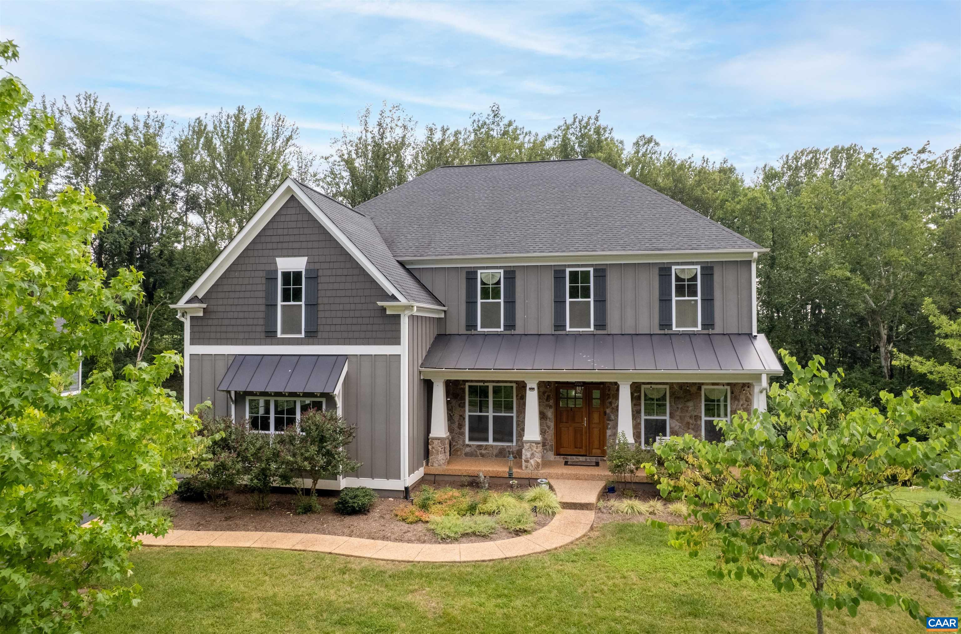 Meticulously maintained custom home by Craig Builders offers exceptional finishes and is located in the highly desirable Hyland Ridge neighborhood. Situated on a private 0.46-acre lot with mountain views, near Pantops, Darden Towe Park, MJH, with easy access to I-64 & 250. This flexible floor plan features hardwood floors throughout the main level, including a secondary primary bedroom with an attached bath—perfect for a mother-in-law suite or those seeking a bedroom on the main level. The layout also includes a home office with high-speed internet, a 2-car garage, a formal dining room, a butler’s pantry, and an open-concept kitchen and living space. The kitchen and family room showcase an oversized island, coffered ceiling, high-end ss appliances, bright breakfast nook, & gas fireplace. The second level features an oversized master with a luxurious bath, including dual vanities, tiled shower, & soaking tub. A bonus room over the garage provides versatility. The three bedrooms upstairs each include their own private baths. The walk-out finished basement offers a Rec room, bed, full bath, & several unfinished rooms for storage. Enjoy outdoor living on the covered front porch, back deck, or rear patio. Open house this Sun 10/5 1-3!