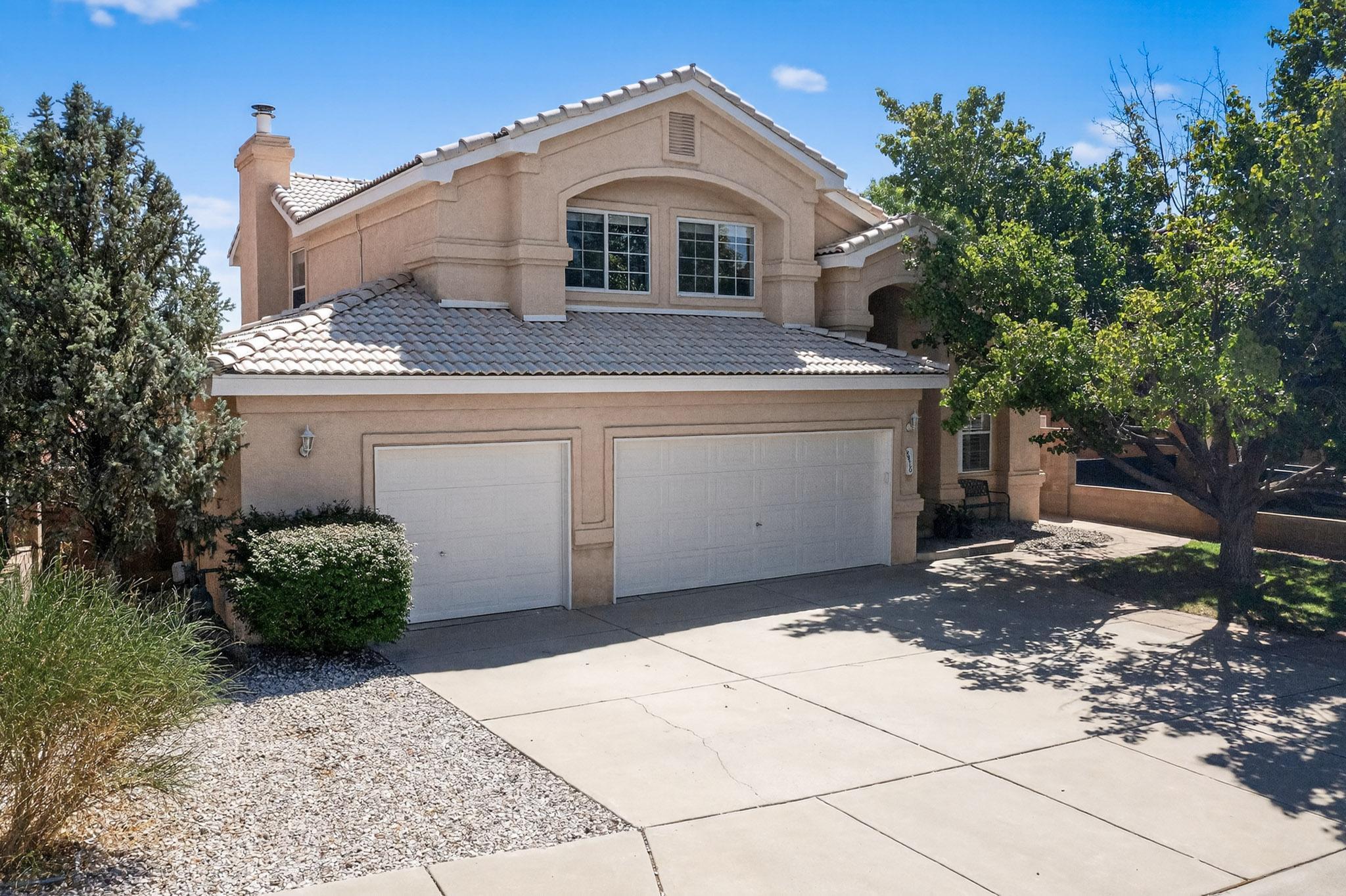 A beautifully upgraded two-story home where comfort, style, and sustainability blend effortlessly. This spacious 5-bedroom residence offers the perfect balance of modern interior and outdoor tranquility. Recent upgrades include remodeled bathrooms, refrigerated air (2019), new carpet, and recent luxury vinyl plank flooring (2023). Enjoy the light and bright interior with high ceilings, cozy wood burning fireplace, and well-appointed kitchen with island and black stainless-steel appliances. (All appliances convey, including washer/dryer) The exterior of the home is just as impressive with a flagstone patio, balcony with views of the Sandias, a backyard arbor and garden with rock wall.  Have peace of mind with the fully paid 5.49 kW DC Tesla rooftop solar system (2018).