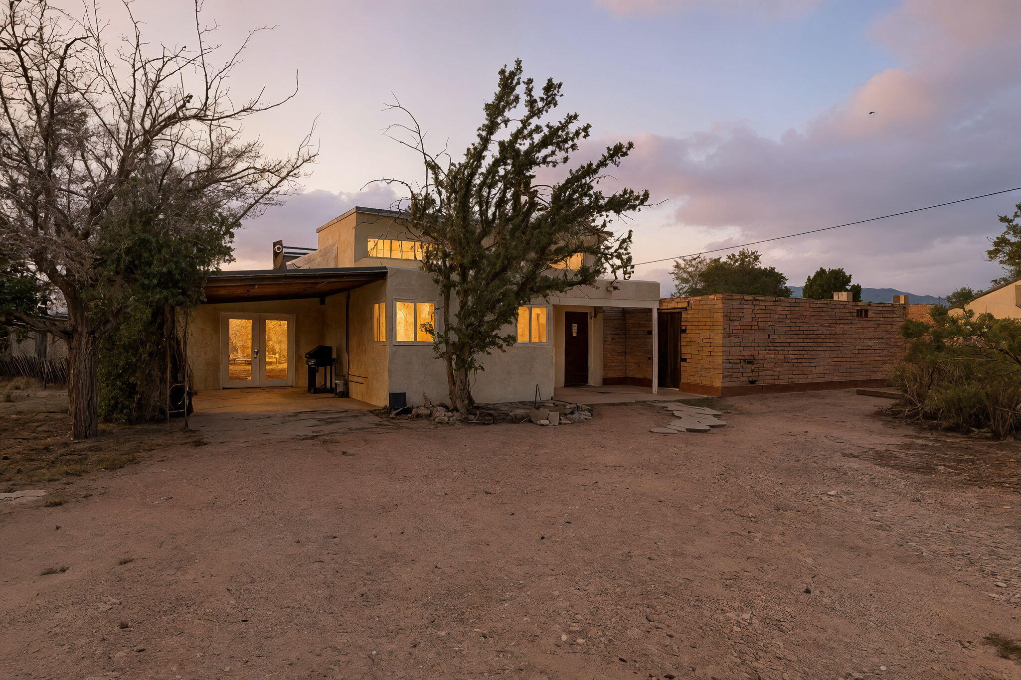 Set on a rare 0.52-acre lot in Albuquerque's North Valley, this distinctive home offers space, charm, and versatility, with plenty of room to make it your own. A mix of rooms and living areas reflects the character of an older home, featuring natural light, wood floors, and Southwestern details. Flexible spaces are perfect for a studio, office, or creative work. The oversized lot provides potential for expansion, landscaping, or possible subdivision. Conveniently located near Old Town, the Sawmill District, I-40, and scenic trails, this property combines opportunity with a prime location.