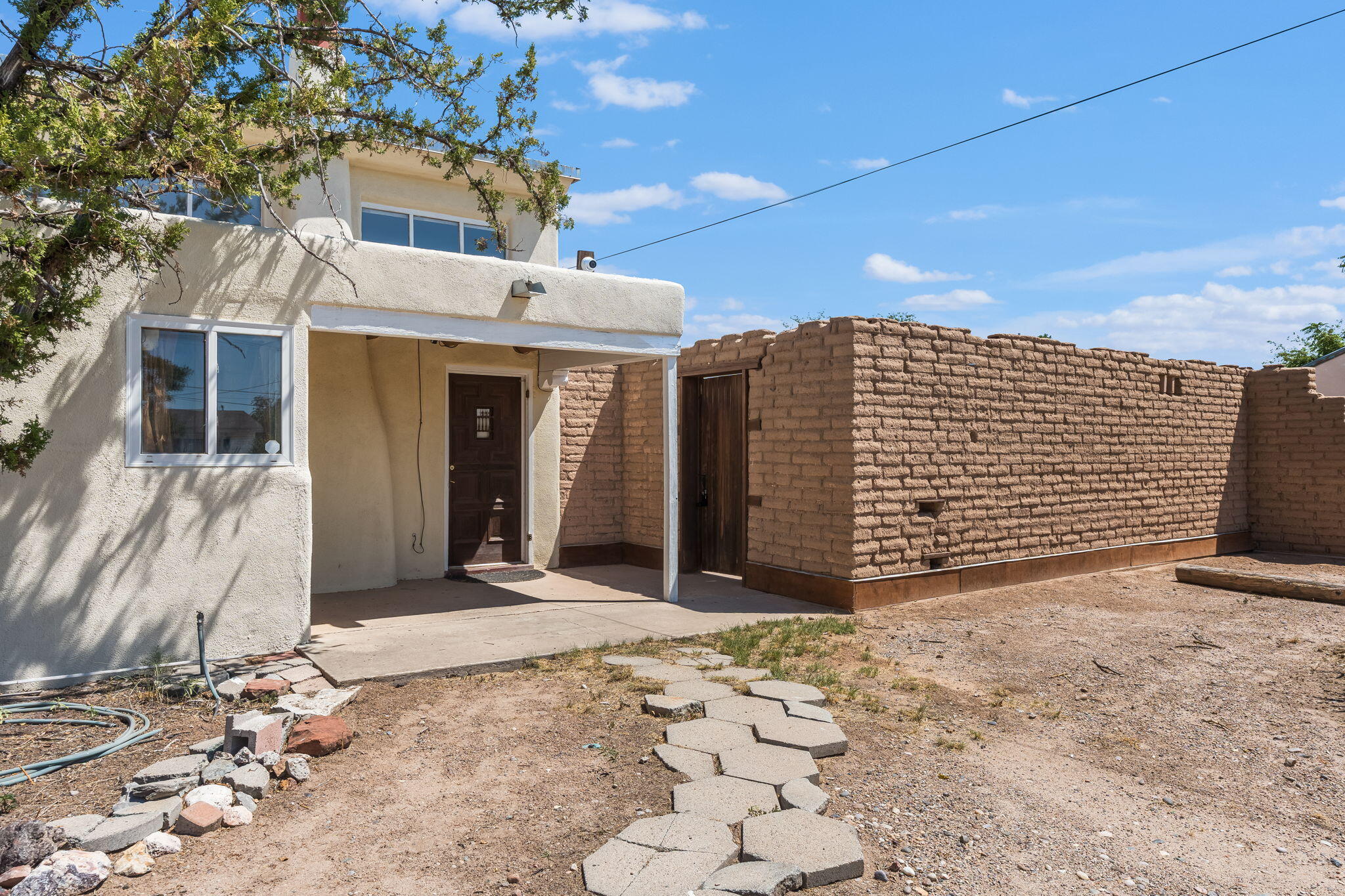 Set on a rare 0.52-acre lot in Albuquerque's North Valley, this distinctive home offers space, charm, and versatility, with plenty of room to make it your own. A mix of rooms and living areas reflects the character of an older home, featuring natural light, wood floors, and Southwestern details. Flexible spaces are perfect for a studio, office, or creative work. New HVAC in Sep 2025. The oversized lot provides potential for expansion, landscaping, or possible subdivision. Conveniently located near Old Town, the Sawmill District, I-40, and scenic trails, this property combines opportunity with a prime location.
