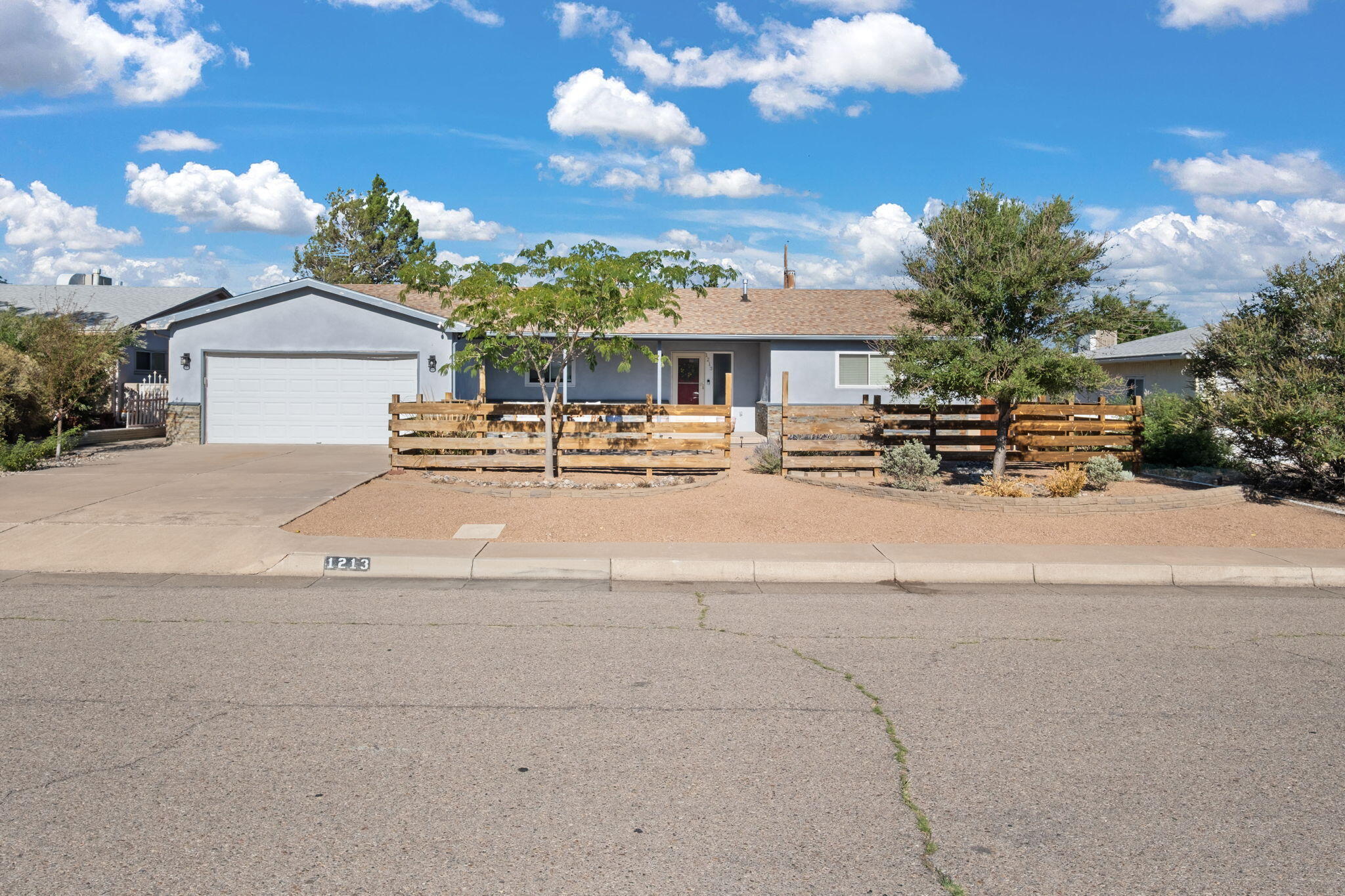 Step into style & versatility in this updated 2-bed Uptown, Albuquerque home, with a large den/3rd bed featuring a cozy wood-burning fireplace. The open floor plan connects spaces, creating an airy vibe. The gourmet kitchen boasts refreshed cabinets, gas range, center island, & elegant lighting. The living room has a fireplace & TV mount. Luxury vinyl floors grace the main areas & primary suite; Bedroom 2 has hardwoods. Updated bathrooms offer stylish vanities & showers. Barn doors & custom finishes add charm. Enjoy an oversized 2-car garage with workshop & a covered patio in a large backyard with gated alley access for a boat or ADU. This flexible, move-in-ready gem in a prime location near Uptown, downtown, & Sandia Mountains is perfect for families or entertainers.