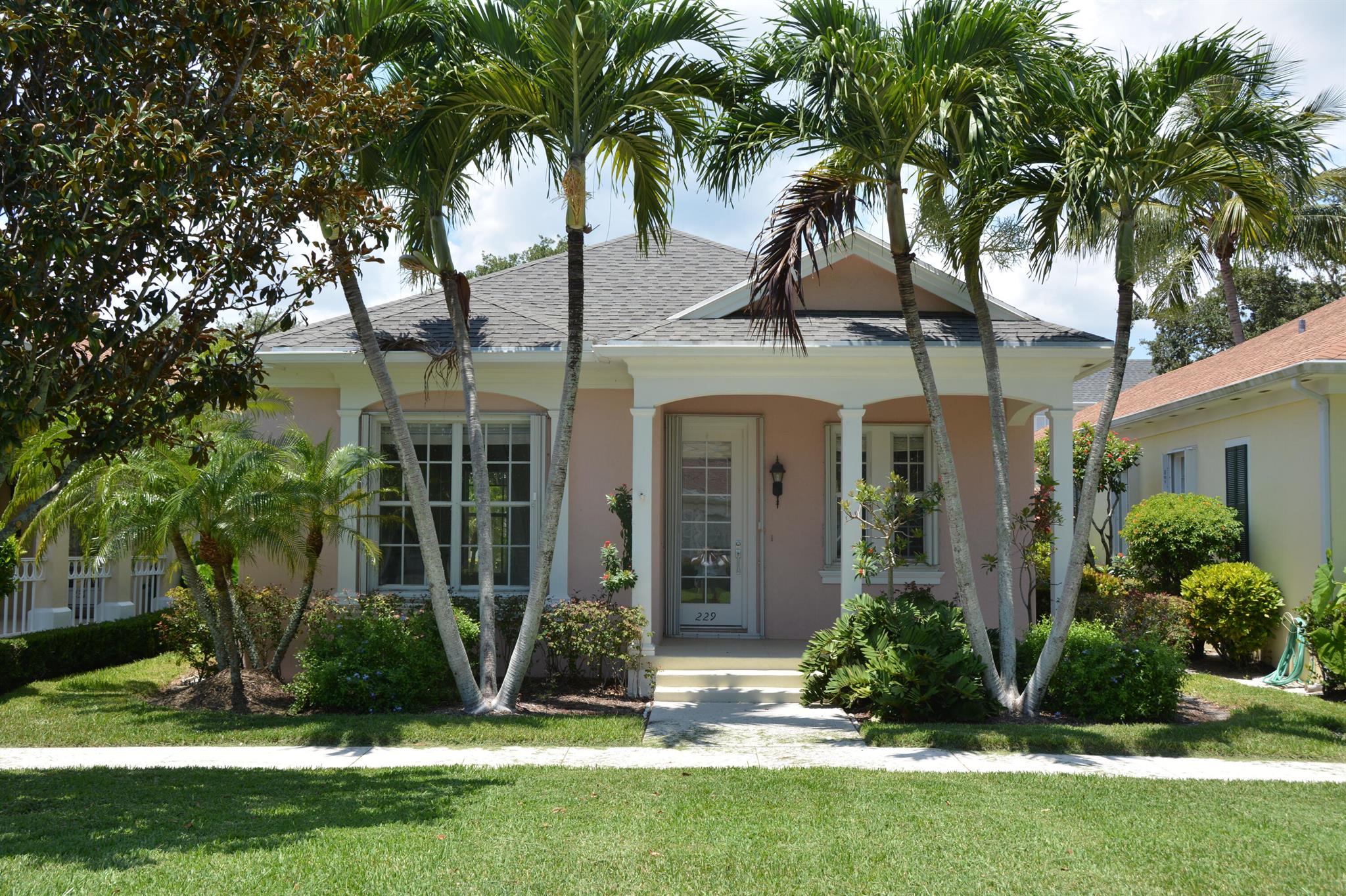 Adorable 2 BR/ 2 BA with fabulous park location.  Sit out on your front porch and just enjoy the sunrise.  Home has been completely repainted inside with Benjamin Moore Chantilly Lace, crown molding in bedrooms and baths, decorator formica countertops in kitchen, screened pool with newly painted pool deck, accordion shutters, seller has left flooring to the new buyers choosing.  A credit will be applied at closing for a new roof (Seller has obtained a quote).