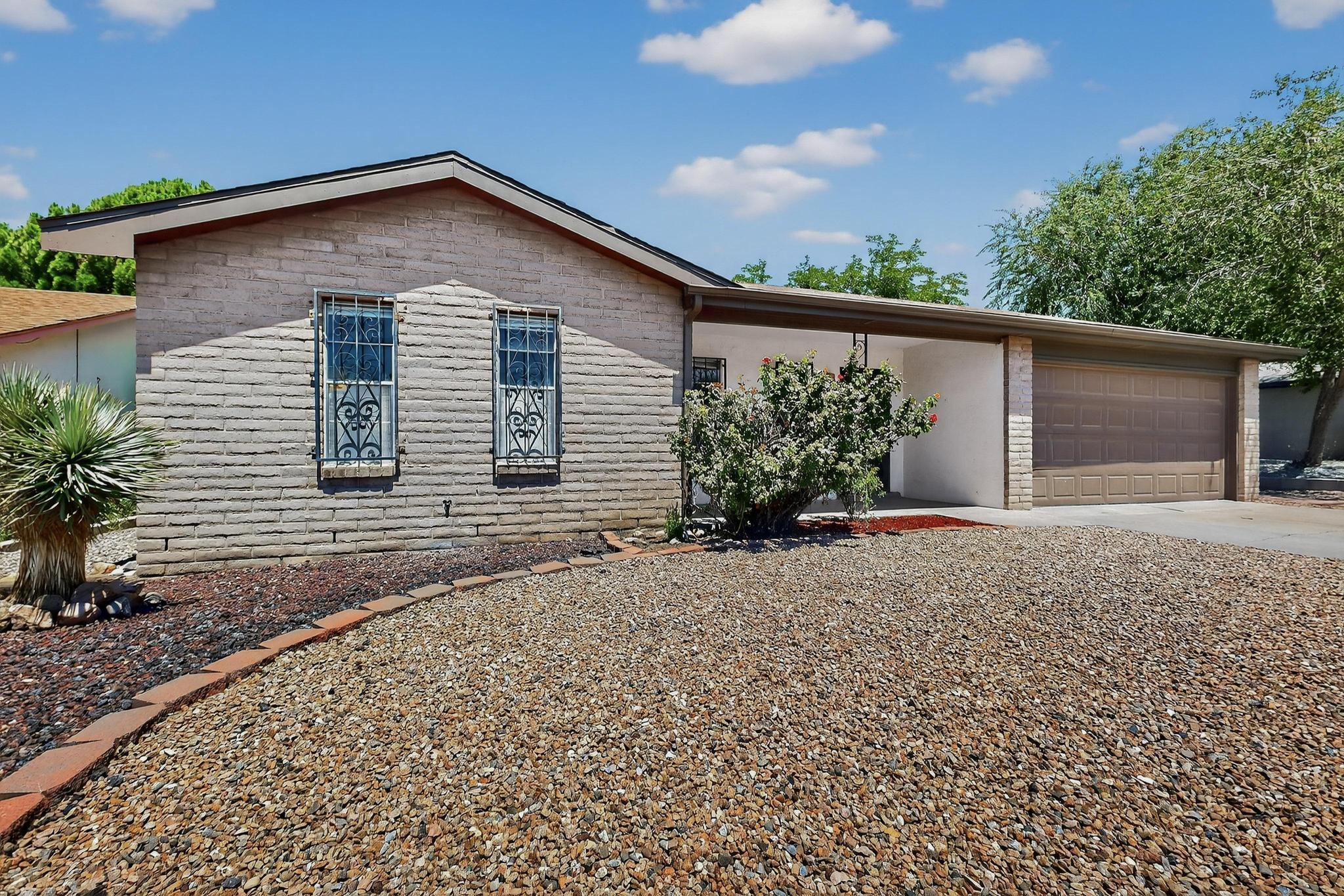 You'll love living in the heart of Academy Acres in this well-designed and retouched home. Original features like the wood fireplace, vaulted ceiling, and wood paneling pair nicely with the fresh paint and newer flooring. The extra space in the back yard is a unique feature for you to enjoy, and if you need even more room to roam, Sister Cities Park is just a few blocks away. All three bedrooms have amazing natural lighting, and are more spacious than similar homes in the area. Having a covered front porch and covered back patio adds to the indoor-outdoor living possibilities year-round! Within minutes in every direction are incredible dining, shopping, grocery stores, and medical offices. Don't miss out on this one!