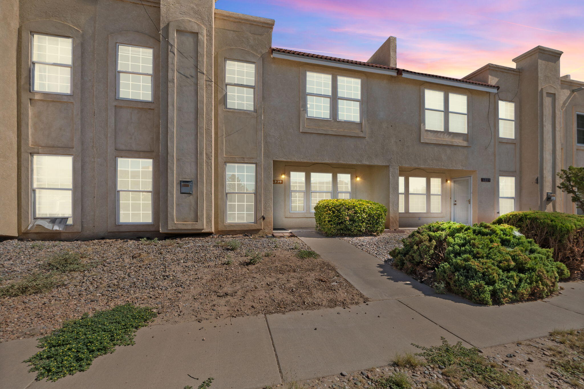 Check out this inviting 3-bedroom townhome that offers two stories of living space and a fantastic location! With 2025 updates including a new TPO roof and evaporative cooler, you'll enjoy both comfort and energy efficiency. The kitchen features a new dishwasher, range, and microwave. The mix of new vinyl flooring, new carpet & fresh paint gives a bright touch. In the back, there is a 2 car garage and a gated courtyard. Easy access to I-40 and close to restaurants and shopping, Come see for yourself!