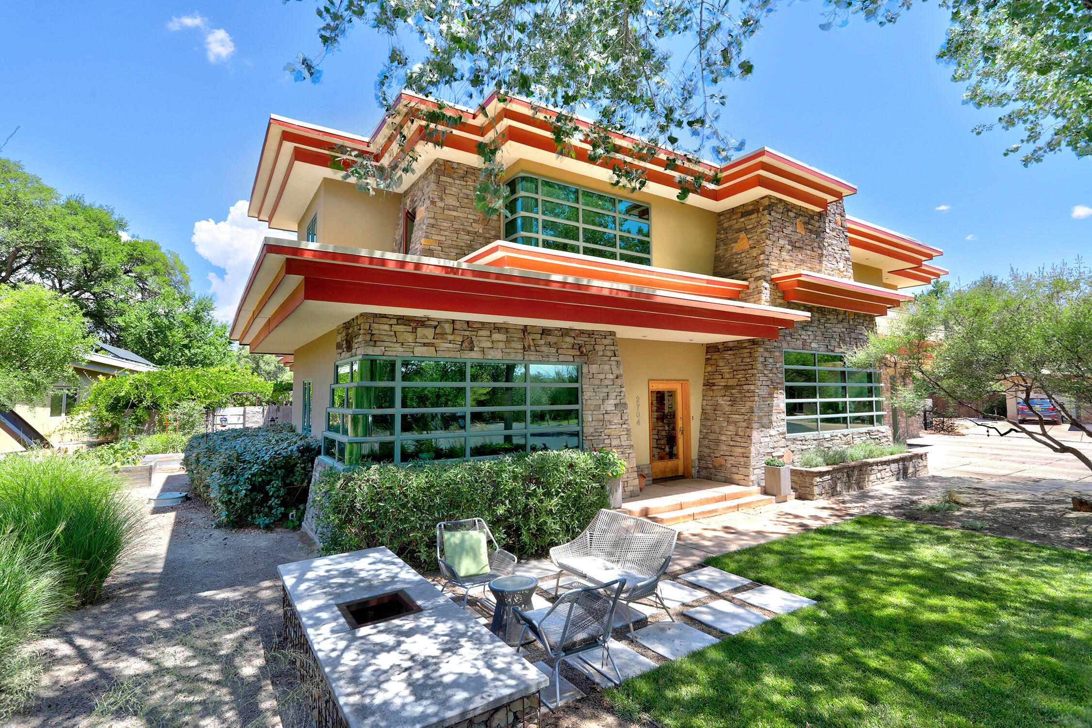 Absolutely stunning contemporary mid-century modern custom home situated on a private and secluded gated street literally steps from the bosque. Gorgeous entry with artistically designed staircase and serene living room with built-ins, fireplace and amazing views of the bosque. Fabulous remodeled gourmet kitchen with custom cabinetry, stainless steel appliances, granite countertops, tons of counter space/storage and custom banquette seating. Updated dining room with beautiful tile, built-ins and wine cooler. Luxurious main floor primary suite with wonderful newly remodeled bath. Huge secondary bedrooms all have en suite bathrooms. Impressive flex space - could be 3rd living area or in-law quarters. Screened in porch with FP leads  to redesigned backyard oasis. 3 car garage w/radiant heat.
