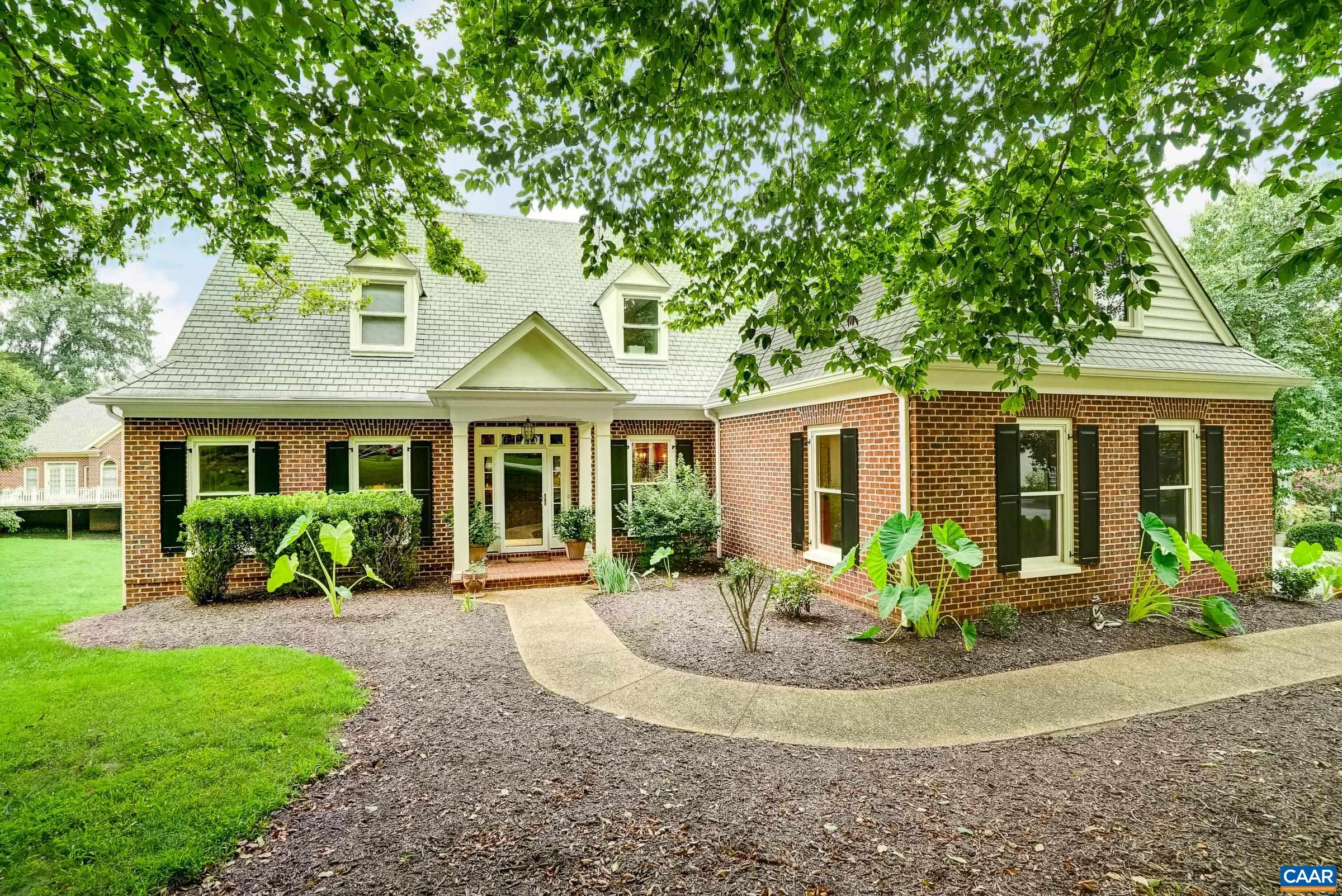 Impeccably maintained and thoughtfully cared for, this handsome brick home is nestled within the prestigious gated community of Glenmore. Offering timeless curb appeal and quality craftsmanship, this property is a rare find. Step inside to a beautifully detailed formal living and dining rooms, featuring elegant cased openings and extensive moldings, including chair rail accents. The light-filled great room boasts a soaring cathedral ceiling, creating an open and airy atmosphere ideal for relaxing or entertaining. The kitchen is a chef's delight, showcasing stainless steel appliances, granite countertops, a central island, and a breakfast bar. A spacious dining area just off the kitchen pens to a rear deck-perfect for morning coffee or evening gatherings. Rich hardwood floors flow throughout the main living spaces. The main level includes a convenient primary suite, while the second floor offers three additional bedrooms and two full baths, providing ample space for family or guests. The full unfinished basement offers a wood-burning fireplace and a rough-in bath, presenting endless possibilities for future expansion. Purchaser can get 25% off of the initiation to The Club at Glenmore if they join within 30 days of closing.