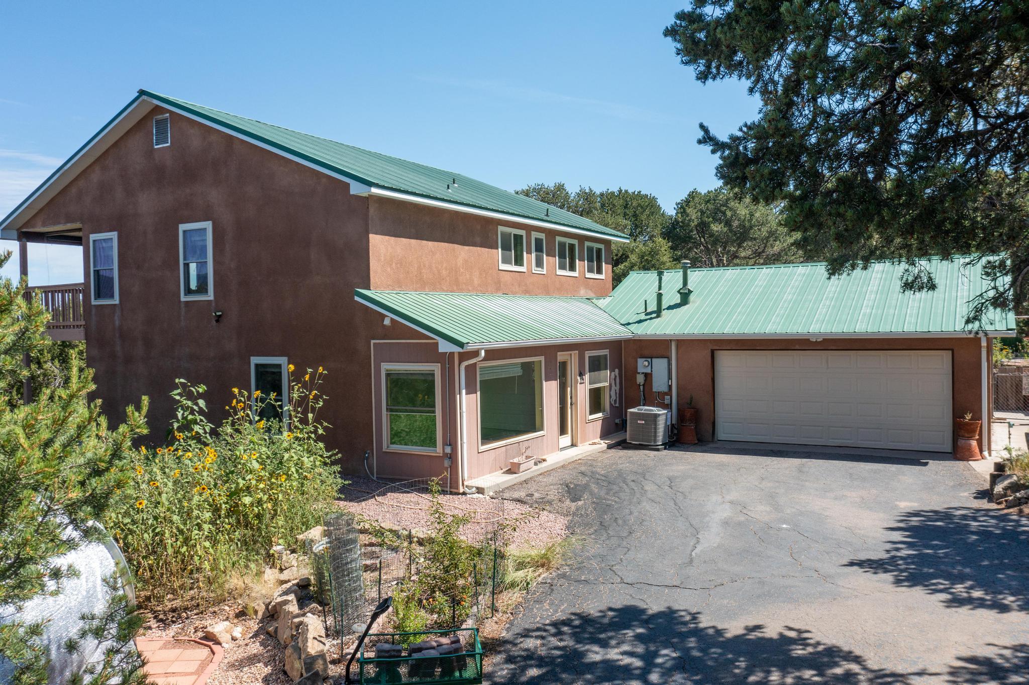 Escape to this stunning mountain retreat on 4.5 private acres! Enjoy breathtaking views, a beautifully manicured garden, and plenty of space to relax and connect with nature. The home features a cozy loft, wood-burning stove, abundant natural light, a balcony perfect for taking in the scenery. and a porch perfect to share a meal and enjoy the views.  Unwind in the hot tub under the starry sky or tend to your garden oasis. Private drive ensures peace and seclusion yet shopping and amenities are just a short drive away. A true sanctuary from city life!  Schedule your showing today.