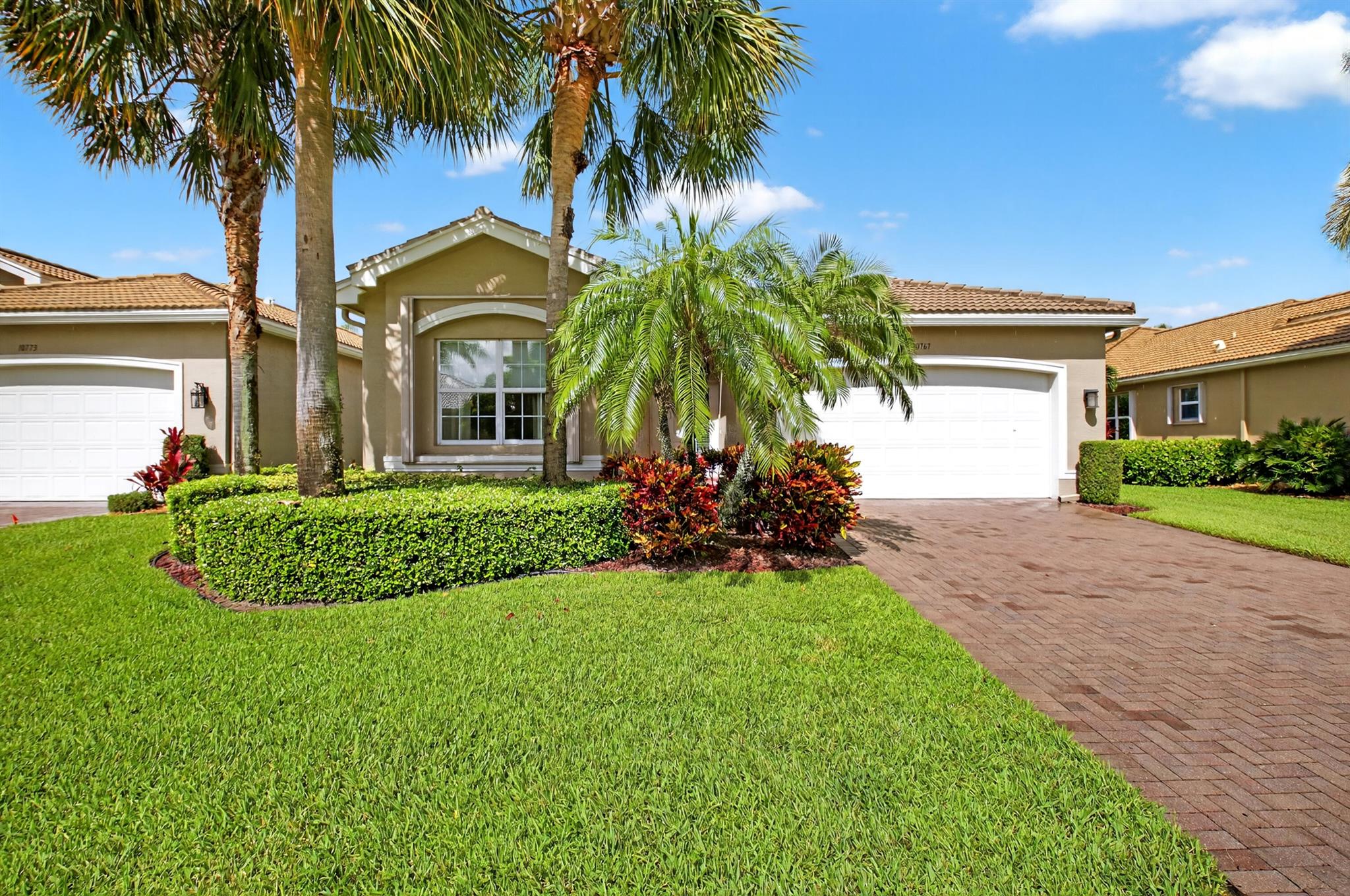 This much sought after pristine Atlantic Grand model features an open floor plan with a light and large family room overlooking a beautiful tranquil lake view.  This wonderful home features newer A/C, newer H20 heater (2023) and complete hurricane protection. Current den can convert to third bedroom. The open kitchen features granite countertops, stainless appliances, beautiful tiled backsplash, high counter snack bar, and an open breakfast area. Patio features travertine flooring. Wonderful closet space (2 in master with built ins)  and large master bath with dual sinks, separate tub and walk in shower. You will not be disappointed! Move right in! Valencia Reserve one of GL's finest senior active communities features country club amenities and lifestyle without the expensive dues