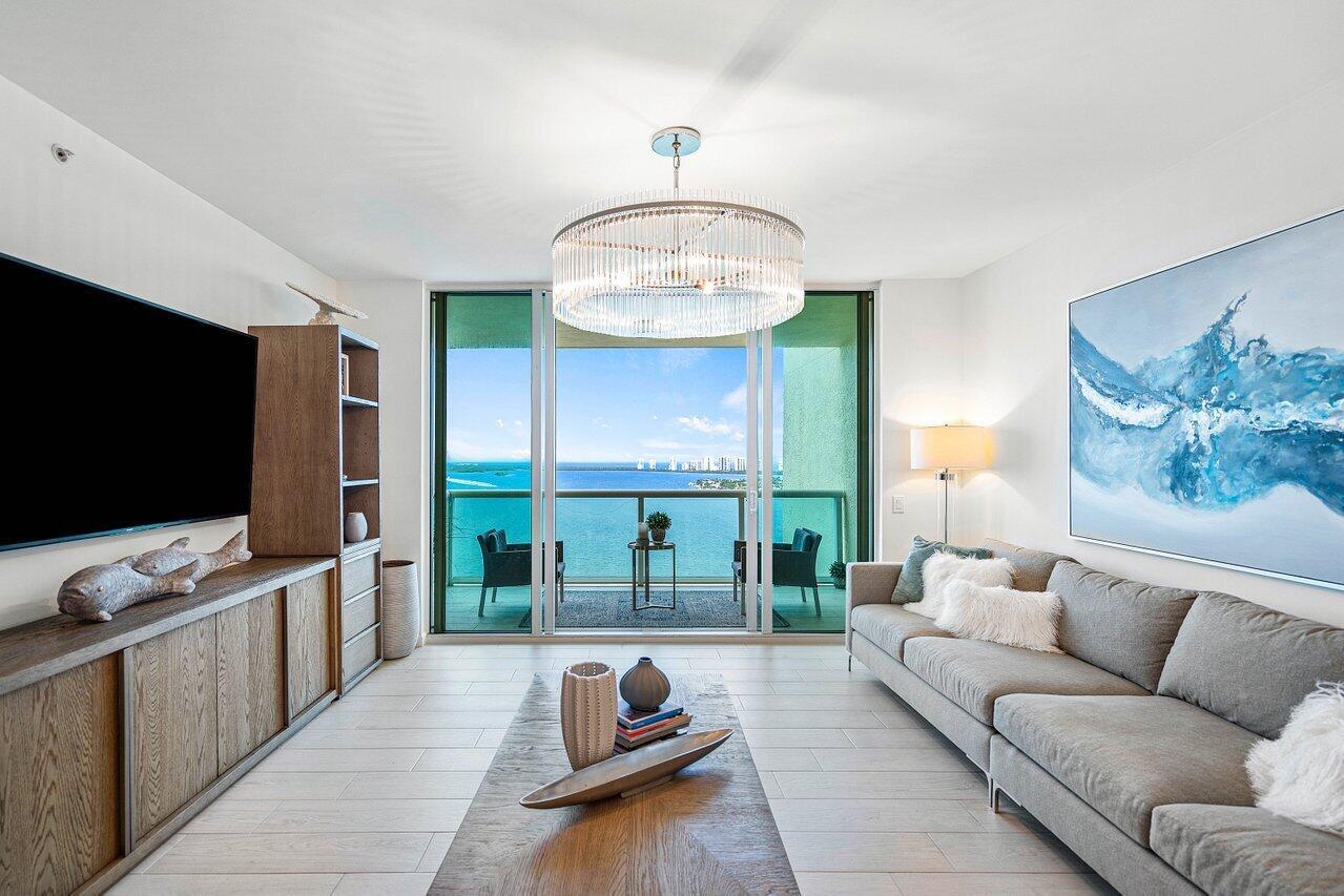 COMPLETELY REMODELED in 2021 - EXQUISITELY FURNISHED! This fabulous 2BR + den (easily converts to 3rd BR) was professionally renovated & elegantly furnished by renown Design Guild Interiors of Jupiter, FL with a sophisticated ''Urban Beach Lifestyle'. The design package includes porcelain plank floors, glass shower enclosures, upgraded vanities,  custom kitchen w quartz countertops, custom closets. Available furnished. 3 flat screen TVs. This is Florida Lifestyle at its finest- Newly renovated rooftop oasis w/pool, spa, BBQ areas, tennis, pickleball, bocce. Clubhouse, billiard room & fitness center. 24 hr manned gate, temperature controlled storage, walk to Publix.  Marina w/dry docks available. Jump on your boat effortlessly & be on the ocean in minutes; no fixed bridges! Pet friendly.