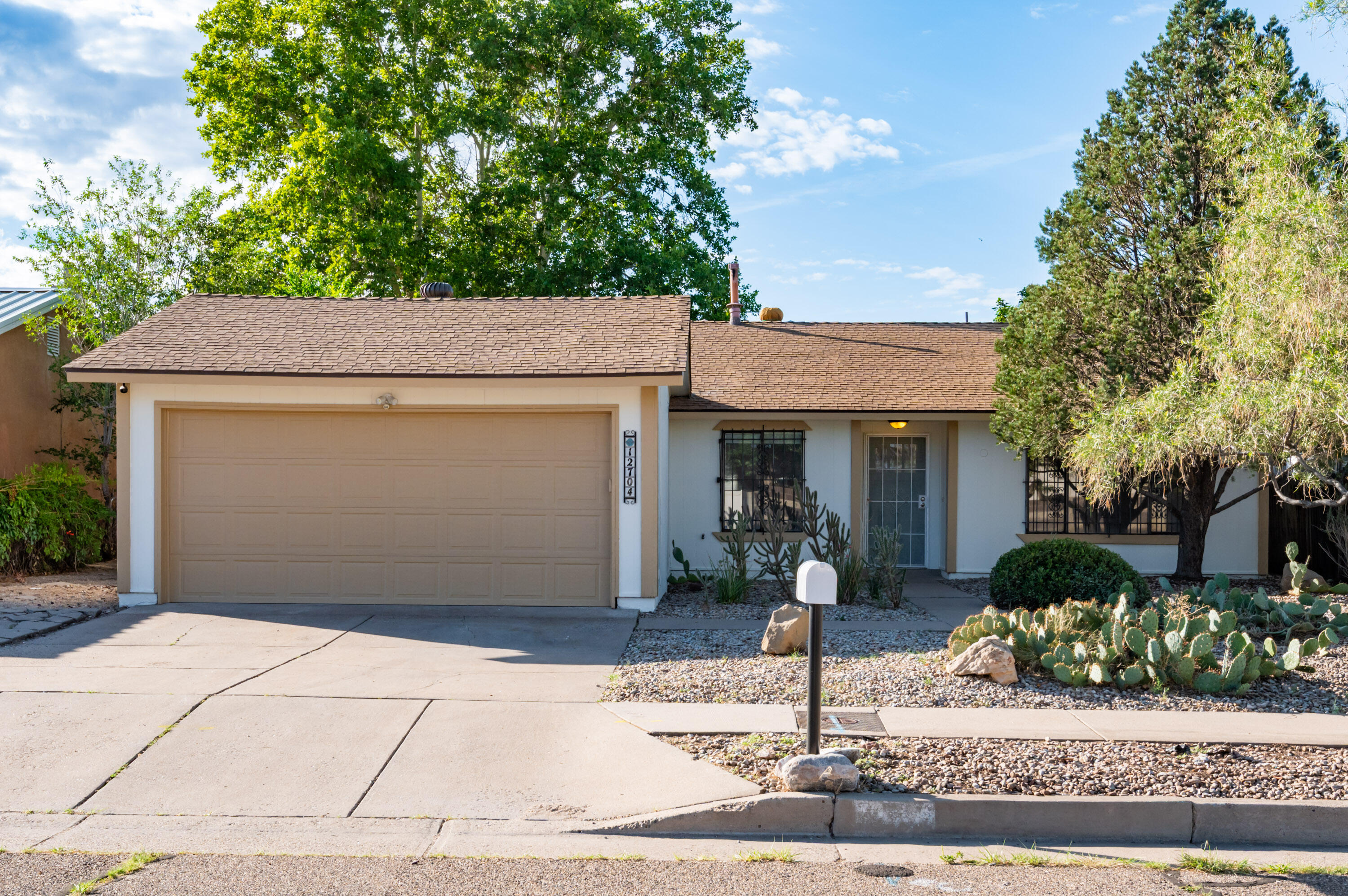 Come take a look at this beautifully refreshed and move-in-ready single-level gem, which showcases brand-new interior and exterior paint, a professionally overhauled landscape, and timeless curb appeal. Inside, the open-concept kitchen shines with granite countertops, custom lighting, and stainless steel appliances, flowing seamlessly into the spacious living and dining areas, which are anchored by a charming fireplace. The generous primary suite offers dual closets and a private bath, while two additional bedrooms provide flexibility for guests or home office space. Enjoy mature trees, a covered patio, and a peaceful backyard setting. Conveniently located near Kirtland AFB, Costco, and easy freeway access.
