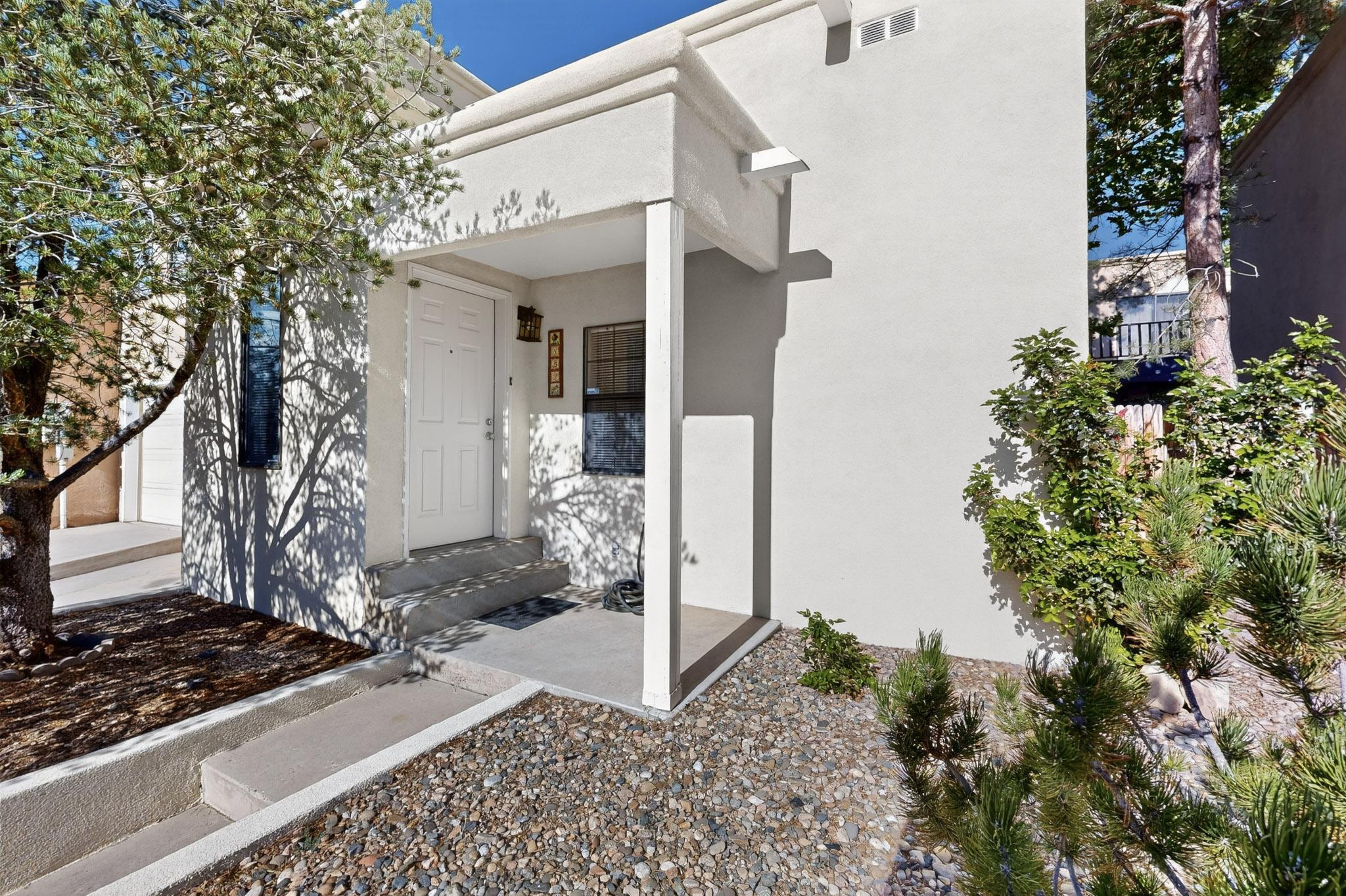 This Beautiful 2 Bedroom Townhome near the base of the Sandia Mountains faces to the west side with City Views from the top bedroom in the front of the home.  This Townhome has a beautiful Balcony off the Master bedroom to enjoy the outdoors.  Balcony was just redone this month along with New Paint and Carpet also New Stainless-Steel Microwave, Stove and Dishwasher.  Heater and Water Heater were replaced in 2022 and the Stucco and Roof were re-done in August of 2020.   Beautiful Private Backyard to enjoy BBQs.   Living area boasts a Gas FP.  Garage is finished with Garage Opener.  Single Owner Home since it was built.