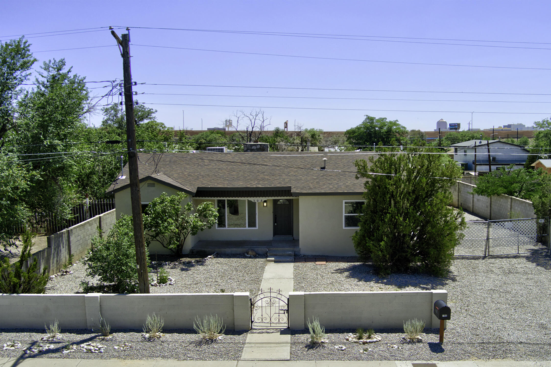 Welcome to this fully renovated single-story 4-bedroom, 2 bath home, offering modern upgrades and move-in ready comfort. Sitting on a generously sized lot with RV parking, a large backyard, and a single-car garage, this property checks all the boxes. Step inside to discover a freshly painted interior and exterior, brand new luxury vinyl plank flooring, plus new carpet in the bedrooms, and a stylish new light fixtures and hardware throughout. The stunning kitchen features all-new cabinets, granite countertops, eye-catching tile backsplash, and brand new SS appliances- perfect for everyday living and entertaining. Both bathrooms have been completely refreshed with new vanities, floor and shower tile, and contemporary finishes. Additionally: NEW vinyl windows, roof, water heater, and cooler