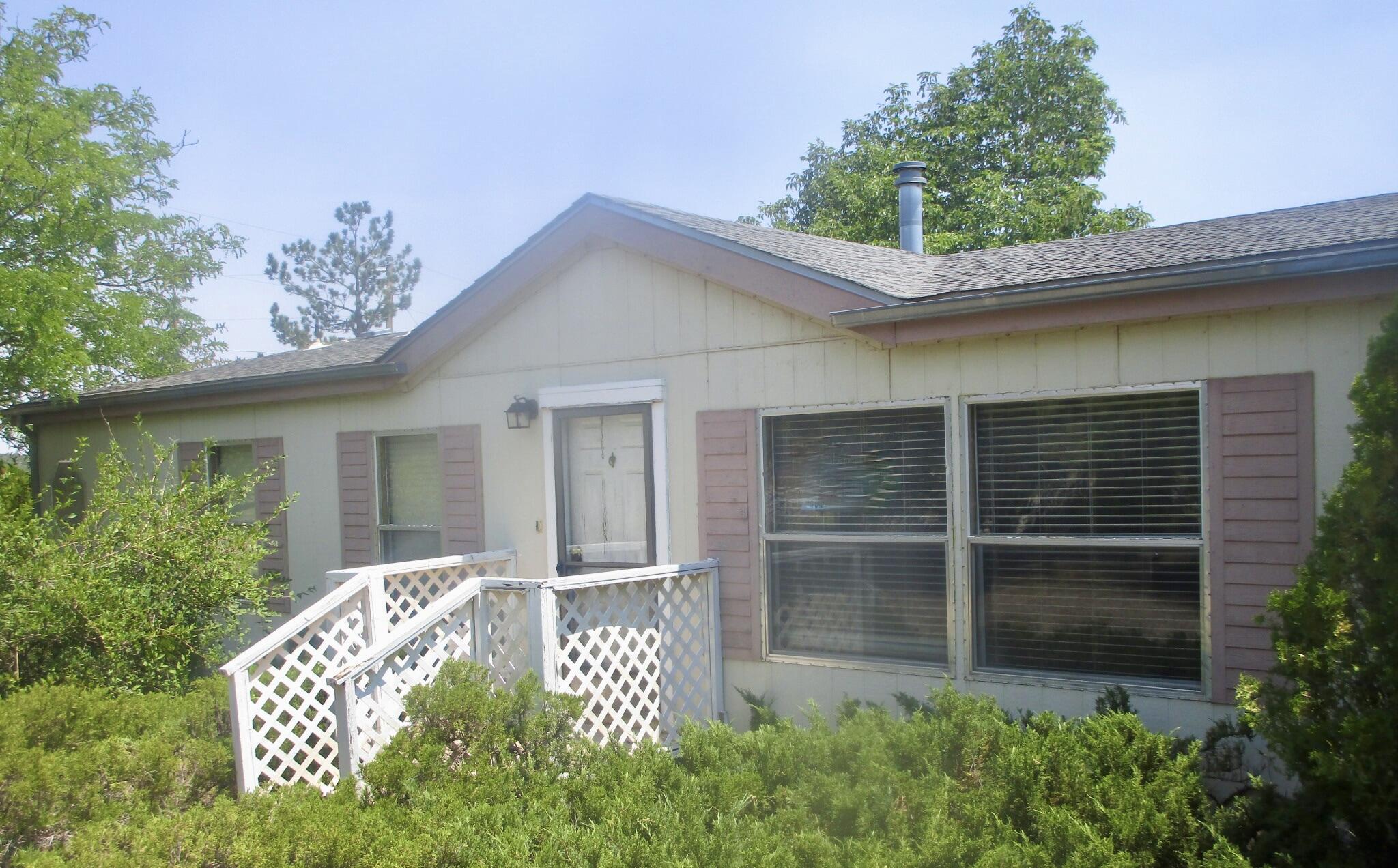 Don't miss this opportunity! This 3-bedroom, 1.75-bath, 1,400 sq. ft. manufactured home offers plenty of living space on a 1-acre corner lot. Features include a 1-car carport, a large backyard ideal for outdoor living, and an enclosed patio. Inside, the open living room flows seamlessly into the kitchen and breakfast nook, creating a warm and inviting layout. Enjoy peaceful country living while still being just minutes from shopping, dining, schools, and recreation. This location offers the best of both worlds--quiet surroundings with local town amenities close by. Schedule a showing today! Bank-approved short sale--CASH ONLY! Sold as-is; buyers should conduct their own inspections. All offers answered within 1-2 business days. (Seller does not warrant utility or system functionality.)