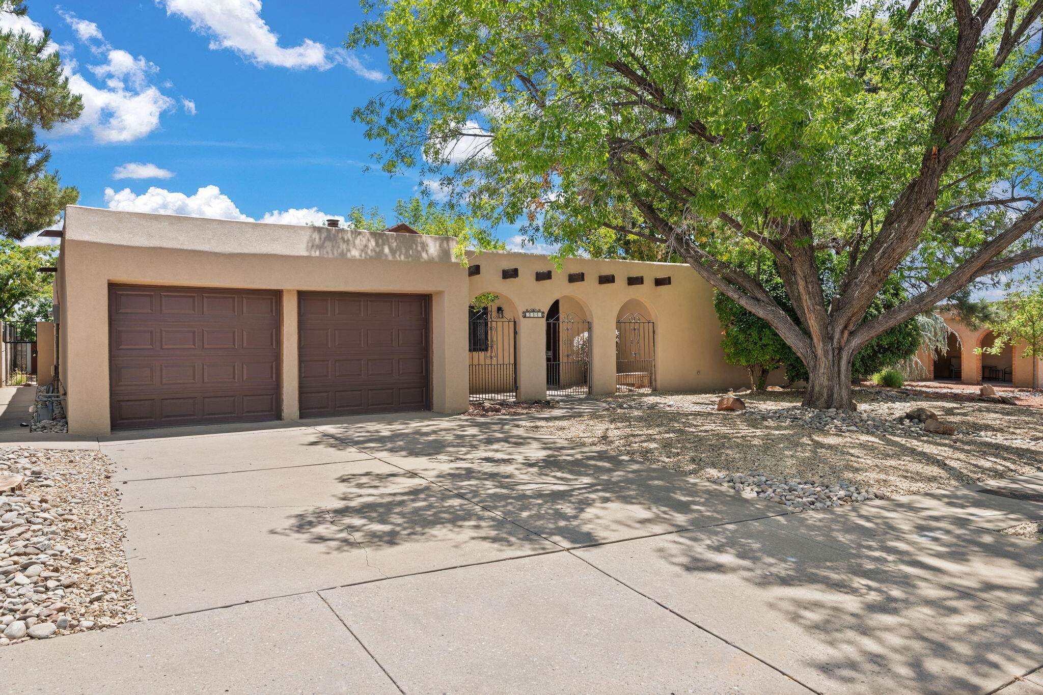 Don't miss out on this meticulously maintained Candlelight home, nestled in the heart of the NE Heights, minutes from the Academy, Whole Foods, and various golf courses. Featuring wood and tile floors, 3 bedrooms, 2 bathrooms, 2 living areas, gas log fireplace, and an open kitchen with backyard access. The adorable backyard provides views of the Sandia Mountains, and has a deep portal fitted with an outdoor fan to provide maximum enjoyment at any time of the day.  The roof was replaced 5 years ago and has a lifetime warranty. Hurry, this will not last!