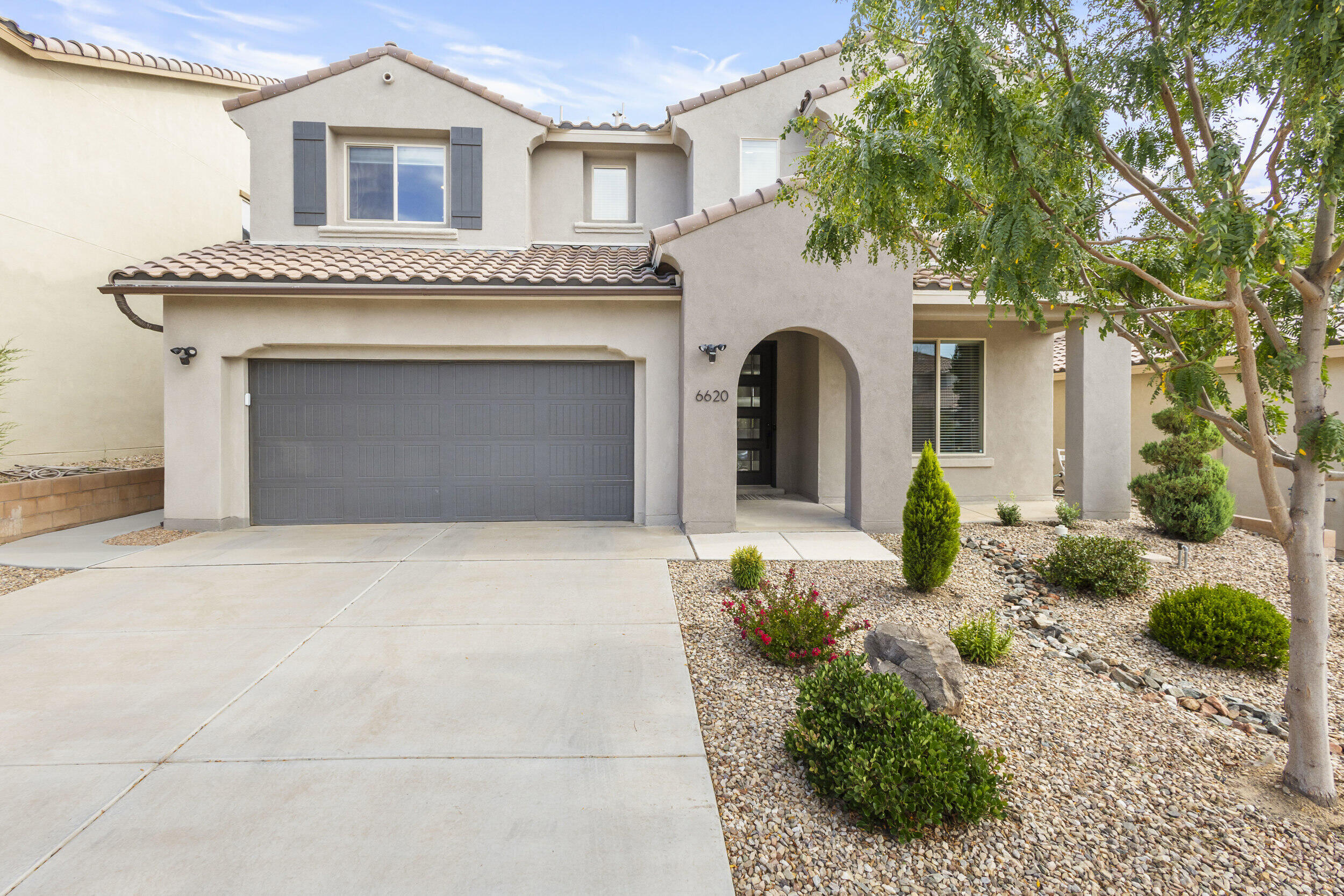 Stunning 3-year-old Pulte home in a gated NE Albuquerque community, perfectly designed for comfort, style, and everyday living.Enjoy thoughtful updates throughout, including a beautiful backyard patio ideal for relaxing or hosting family and friends, plus a purified water system for added convenience. The chef's kitchen is a showstopper -- oversized island, built-in appliances, and open flow that's perfect for entertaining.The main level offers both the owner's suite and a guest bedroom, making multi-generational living or hosting easy. The owner's suite features a large garden tub, bay window, and a walk-in shower for a true retreat feel. Gather around the grand fireplace in the spacious living area, filled with natural light from generous windows.