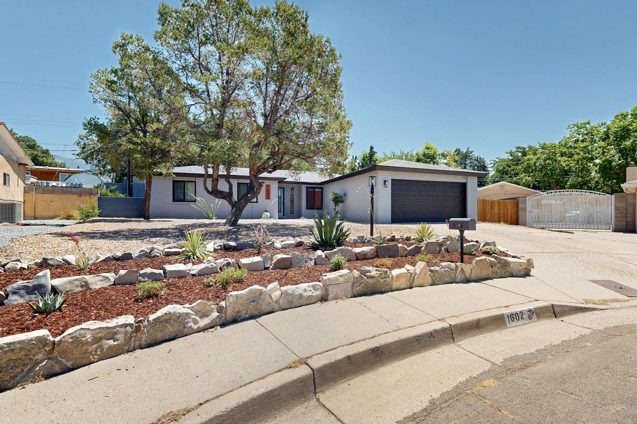 Updated with the Intent to Stay, and it Shows! Sellers' Change of Plan = Your Stroke of Luck! Tucked away on a quiet cul-de-sac, this beautifully remodeled home is situated on a 1/4 ac lot w/ a private, newly landscaped low-maintenance yard and backyard access, a quality synthetic lawn, drought-tolerant plants, and space for your RV or boat! The roof is just 1 year old and features a solar panel that serves specifically to keep A/C cooling costs down. Freshly painted inside and out! Inside, enjoy a cozy fireplace in the open concept living space, newer heater, and double-pane windows for year-round comfort. The primary suite includes a full bath, and there's an enclosed sunroom/porch for extra living or hobby space. The large shed w/ loft features electricity and water is nearby if plumbing