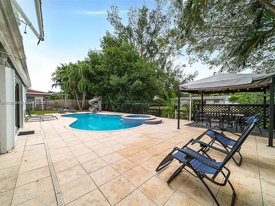 Waterfront 5-bedroom, 3-bath pool home with waterslide in sought-after Enchanted Lake! Enjoy ocean-access canals perfect for jet skis. Located in a quiet, family-friendly community with top-rated schools. Currently a successful short-term rental, offering strong income.
