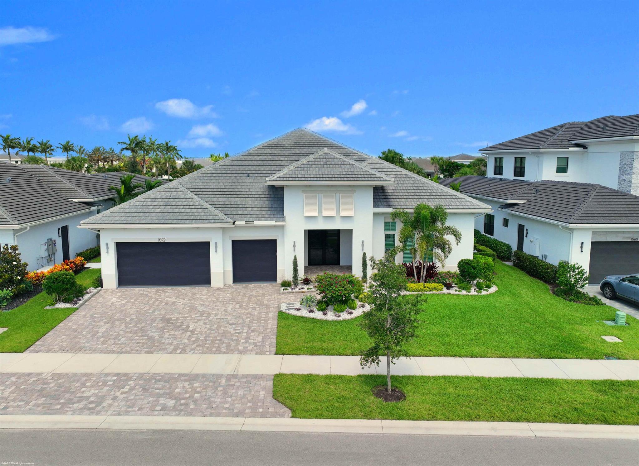 Experience refined Florida living in this exquisite 5-bedroom, 4.5-bathroom estate, perfectly positioned in one of Palm Beach Gardens' newest gated communities- Coral Isles at Avenir. Designed for both elegance and comfort, this single-story home offers exceptional craftsmanship, a thoughtful open-concept layout, and an outdoor oasis that rivals any resort.  From the moment you arrive, the home's striking curb appeal sets the tone. A paver driveway leads to the spacious 3-car garage, while lush tropical landscaping, enhanced by professional landscape lighting, welcomes you to the front entry. Inside, soaring ceilings, expansive windows, and designer finishes create a light-filled, inviting atmosphere. Open Concept Living at Its Finest
The heart of the home is an expansive great room seamlessly connecting the living, dining, and kitchen spaces; perfect for entertaining or relaxing with family. Walls of glass frame views of the custom pool and outdoor living area, blurring the line between indoor and outdoor spaces. The gourmet chef's kitchen features top-of-the-line appliances, a large center island with seating, custom cabinetry, and sleek quartz countertops. The adjacent dining area and living room, with elegant lighting and designer details, ensure every gathering feels special.

Private Bedroom Retreats
With five spacious bedrooms, each with its own en-suite bathroom, this home provides privacy and comfort for every member of the household. The primary suite is a true sanctuary, complete with a spa-like bathroom featuring a soaking tub, oversized walk-in shower, and dual vanities. Large walk-in closets offer abundant storage. Enjoy panoramic views of paradise (in your own backyard).

Resort-Style Outdoor Living
Step outside to a backyard designed for year-round enjoyment. The custom pool, complete with a heated spa, invites relaxation, while the summer kitchen and fire pit, makes hosting unforgettable gatherings a breeze. Expansive covered and open patio spaces provide plenty of room for lounging and dining al fresco. Professionally installed landscape lighting ensures the beauty of the outdoor space shines both day and night.

Community &amp; Lifestyle
This prestigious gated community offers a wealth of amenities for residents to enjoy; think tennis courts, pickleball, clubhouse, fitness center, resort-style pools, walking trails, and more. All of this is set within a meticulously maintained environment that provides security, privacy, and a strong sense of community.

Prime Palm Beach Gardens Location
Located just minutes from world-class golf courses, pristine beaches, upscale shopping, and fine dining, this home combines tranquility with convenience. Enjoy quick access to major highways, top-rated schools, and Palm Beach International Airport, making travel and daily commutes effortless.

Whether hosting large gatherings or enjoying quiet evenings by the pool, this home was designed for those who appreciate the finest in Florida living. Move-in ready and brimming with upgrades. Welcome home to 9372 Coral Isles!