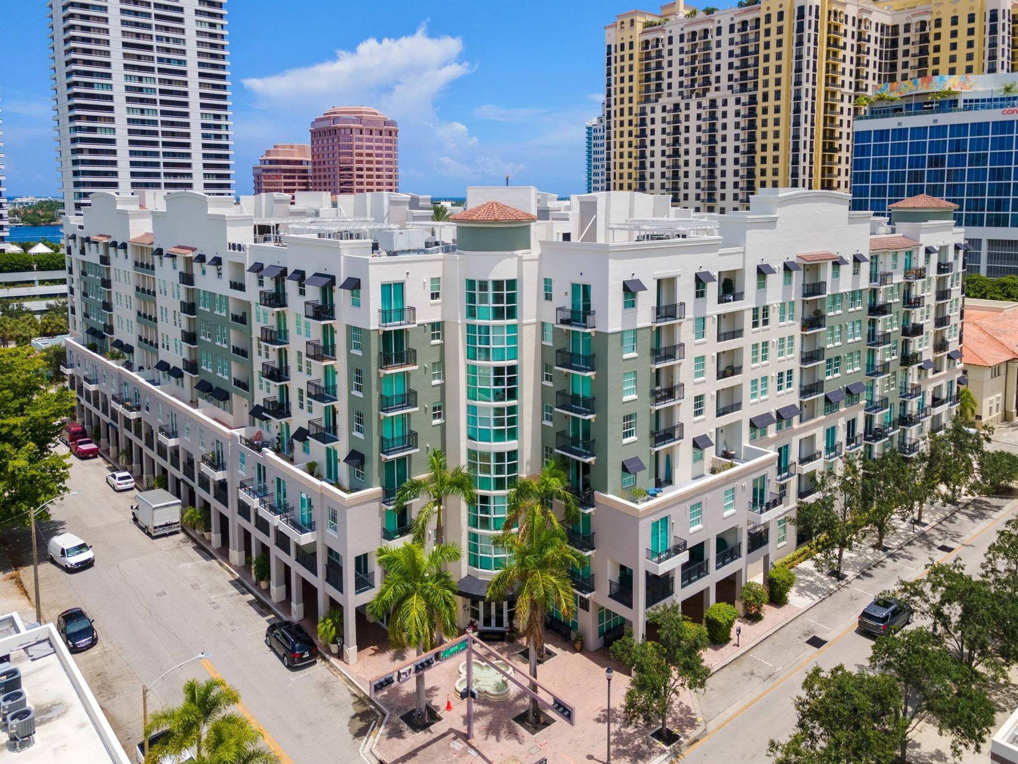 Bask in wonderful light and southern exposure from this elegant high-floor residence at The Prado, where a glimpse east from the balcony reveals sparkling Intracoastal views. Designed with a split floor plan, this home boasts two private master suites, each offering comfort and style. The open-concept layout is anchored by a gourmet kitchen with European cabinetry and granite countertops, seamlessly flowing into the sunlit dining and living areas--perfect for entertaining or simply relaxing. The primary suite features its own private balcony, a custom walk-in closet, and spa-like comfort. Just steps from the elevator, this home offers both convenience and privacy. The Prado's resort-style amenities include a tropical heated pool and hot tub, fully equipped fitness center with updated equipment, renovated club room, business center, bike storage, and a 24-hour attended lobby, with Wi-Fi included. Garage parking adds ease to city living, all in a prime Downtown West Palm Beach location&#x14;minutes from Palm Beach, the airport, and world-class shopping, dining, and cultural attractions.