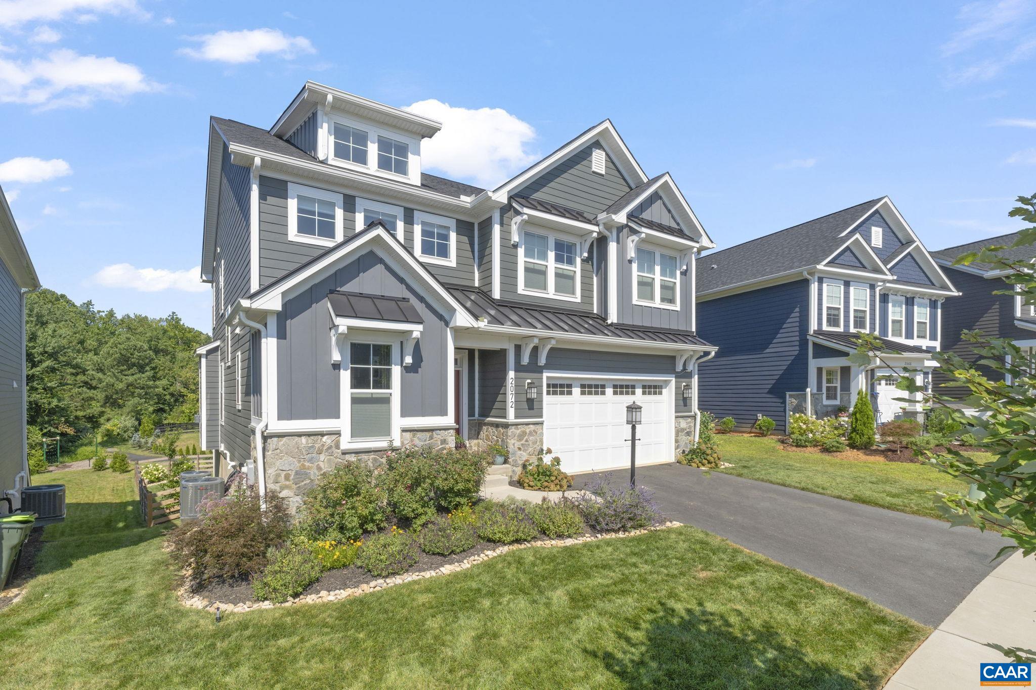 Better than new and backing to woods and a walking trail, this 5BR/3.5BA home offers privacy and upgrades rarely found in the neighborhood. Built in 2022, this floor plan has 3,200+ finished sq ft, including a walk-out basement with rec room, BR, and full bath. The open main level boasts 9’ ceilings, a gas fireplace, and a chef’s kitchen with quartz counters, wood cabinets, walk-in pantry, and oversized island. Upstairs features a spacious primary suite with spa-like bath, three additional BRs, two full baths, and a loft. Outdoor living includes a custom paver patio, fenced yard, and extensive landscaping with mature trees, flowering shrubs, and upgraded drainage. Smart home upgrades: Eufy security system, Yale keyless entry, ceiling speakers. Quiet cul-de-sac, steps to Crozet Trail, minutes to parks, schools & downtown.