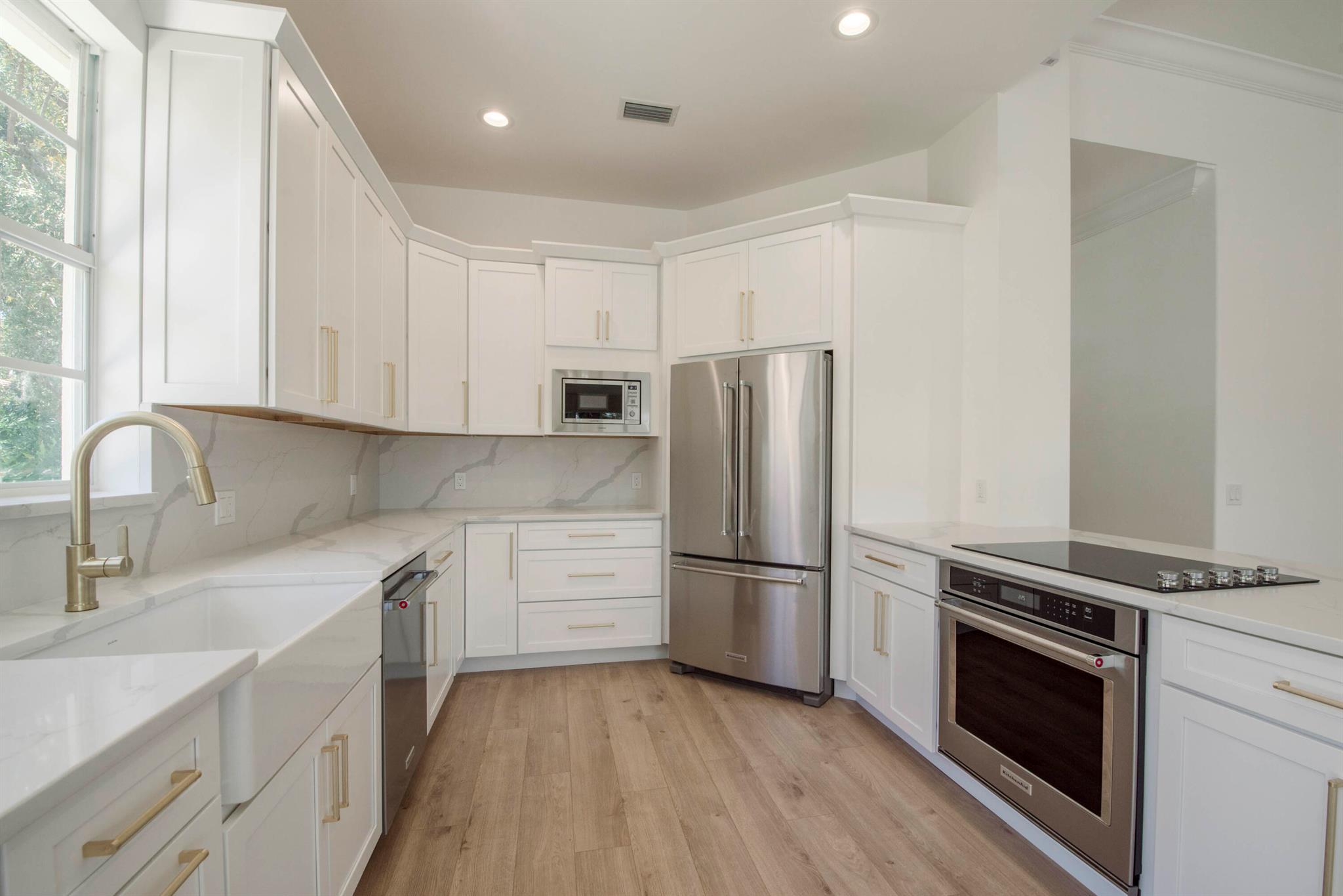 Be the first to put your personal touch on this fabulous and superior newly renovated single family home located in the premier family friendly community of Oaks East.  The gorgeous and spacious eat in kitchen features stunning white custom cabinetry throughout, brand new high end KitchenAid appliances, custom quartz countertops, farmhouse sink, new recessed lighting, a large peninsula open to the main living space perfect for entertaining, and a bonus built in bar/coffee space to enjoy while soaking up the spectacular lake views. The living and dining rooms offer tons of natural light, high ceilings, recessed lighting, durable and waterproof luxury vinyl plank transitionless flooring throughout, and wall to wall sliding glass doors that open onto your tiled screen enclosed outdoor space overlooking the pretty paver patio and wide soothing lake views and lush landscaping... the perfect place to enjoy your morning coffee or wind down after a busy day. Off the living room and through the grand tall double doorway is a generously sized primary bedroom featuring high ceilings and oversized windows to enjoy the stunning lake views, a hall lined with large walk in closets offering ample storage on the way to your spectacular spa like primary bathroom and a half bath with beautiful porcelain tiling, new vanities, wonderful free standing soaking tub, and an oversized shower featuring a frameless glass enclosure. The additional two bedrooms are located on the opposite wing of the home and are extremely sizable with abundant natural light provided by the oversized windows, with plentiful closet and storage space. Off the two guest bedrooms is a beautiful guest bath featuring stunning porcelain tile, new vanity, and new walk in shower separated by a frameless glass panel. Last but not least, don't miss the laundry room featuring brand new washer and dryer, stunning cabinetry, and a custom quartz countertop wrapping the beautiful farmhouse sink.

This newly renovated home features a brand new state of the art barrel tile roof, new gutters, a stunning impact glass front door, new impact skylights, reworked electric, poured concrete construction, brand new plumbing throughout the entire home (no polybutylene pipes), and newer ac and hot water heater. Oaks East, a highly sought after secure and 24/7 guard-gated community and the epitome of location in Palm Beach Gardens, offers magnificent mature oak tree lined and canopied streets, a beautiful heated swimming pool, hot tub, on site property manager, walker friendly sidewalks throughout, and wooded preserve and common areas with benches to take in the views, all included with VERY REASONABLE monthly HOA fees. Adjacent Oaks Park offers a walking trail, two lit tennis courts, and a picnic area while the community is also is conveniently located near to local schools, beaches, parks, endless shopping and restaurants, and is a mere 20 minute drive to the WPB airport. This home is a MUST SEE!