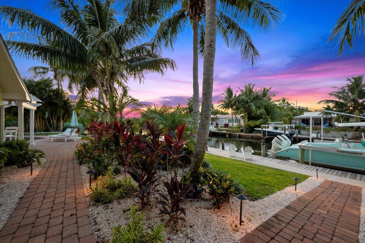 Prime waterfront opportunity in the heart of Juno Isles! This updated 3BR/3BA CBS home w/ split floor plan & new addition added approx. 400 sqft. of living area, which expands the layout to include a den/office, a spacious bonus room, perfect as a 4th bedroom plus Jack & Jill bath. With 130' of waterfront, a 77' dock, 13k lb boat lift, w/ no Fixed Bridges, it's perfect for boaters. New summer kitchen overlooking pool & waterway, updated pool pump, outdoor shower along w/ a Pergola to enjoy the best of your outdoor living space. Other updates include, impact windows & doors 2025, seawall, dock, and batter piles were all redone in 2022. Roof replaced in 2018, kitchen remodeled in 2022, plus more. Located between two inlets, minutes to the beach & dining. The best of South Florida living!