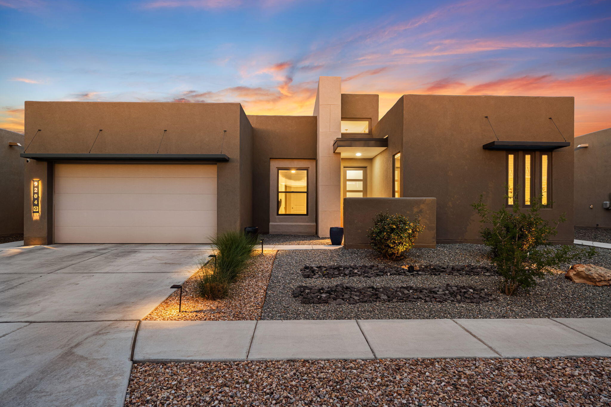 Desert Ridge and La Cueva School Districts! This exquisite Abrazo home, in the coveted, gated community of Ascension. Located just steps away from the iconic Balloon Fiesta Park, this gem offers unparalleled views of the breathtaking Balloon Fiesta each year. Step inside to discover a spacious, open-concept design featuring soaring high ceilings and abundant natural light. The chef's kitchen , boasts custom cabinetry, top-of-the-line appliances, and under-cabinet lighting.Luxurious in-ground swim spa, perfect for year-round enjoyment and the cozy outdoor fireplace. Or enjoy new heights on the rooftop deck, offering sweeping panoramic views - a perfect for watching the hot air balloons or enjoying the New Mexico Sunsets. Too many features to list!  This home is a must see