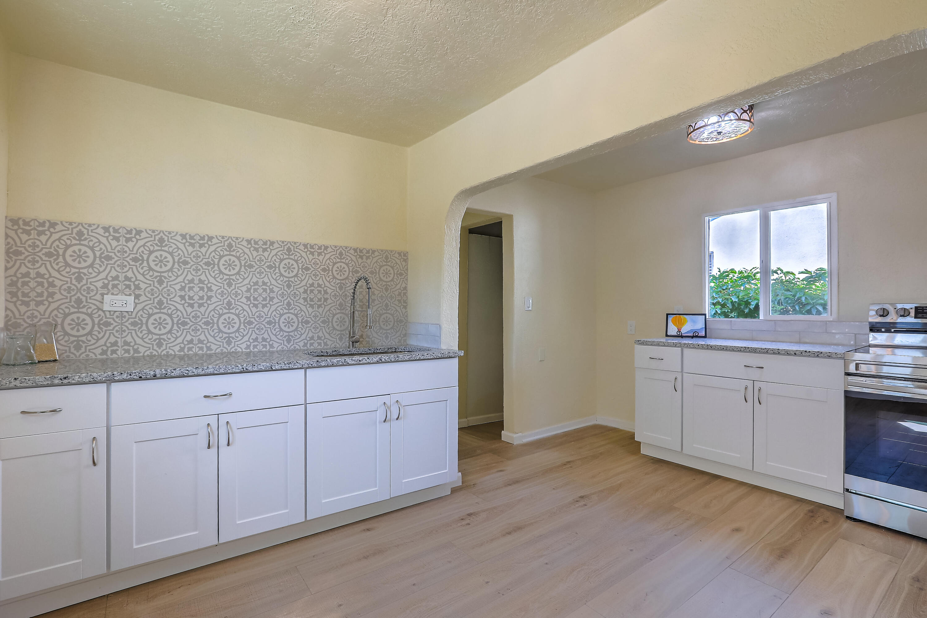 This home features pure personality.It shines bright with adorable new light fixtures that give every room a pop of character.The brand new kitchen is complete with fresh cabinetry, granite countertops and a faucet so fabulous, you might find yourself washing dishes just for fun.Beautiful new flooring flows thoughout, new windows, mini spilts heat/cool, custom color Metal roof! Electricity upgraded with brand new panel and 200 amp service means that you can plug in all your modern toys without a worry.Located in the heart of Barelas.  Minutes from Downtown, ABQ BioPark Zoo, UNM, El Modelo and Barelas Coffee Shop.Tucked away on a quiet dead-end street, just steps from the Bosque Trail - perfect for a morning stroll, sunset jog, or meandering walks when you just need a little nature fix