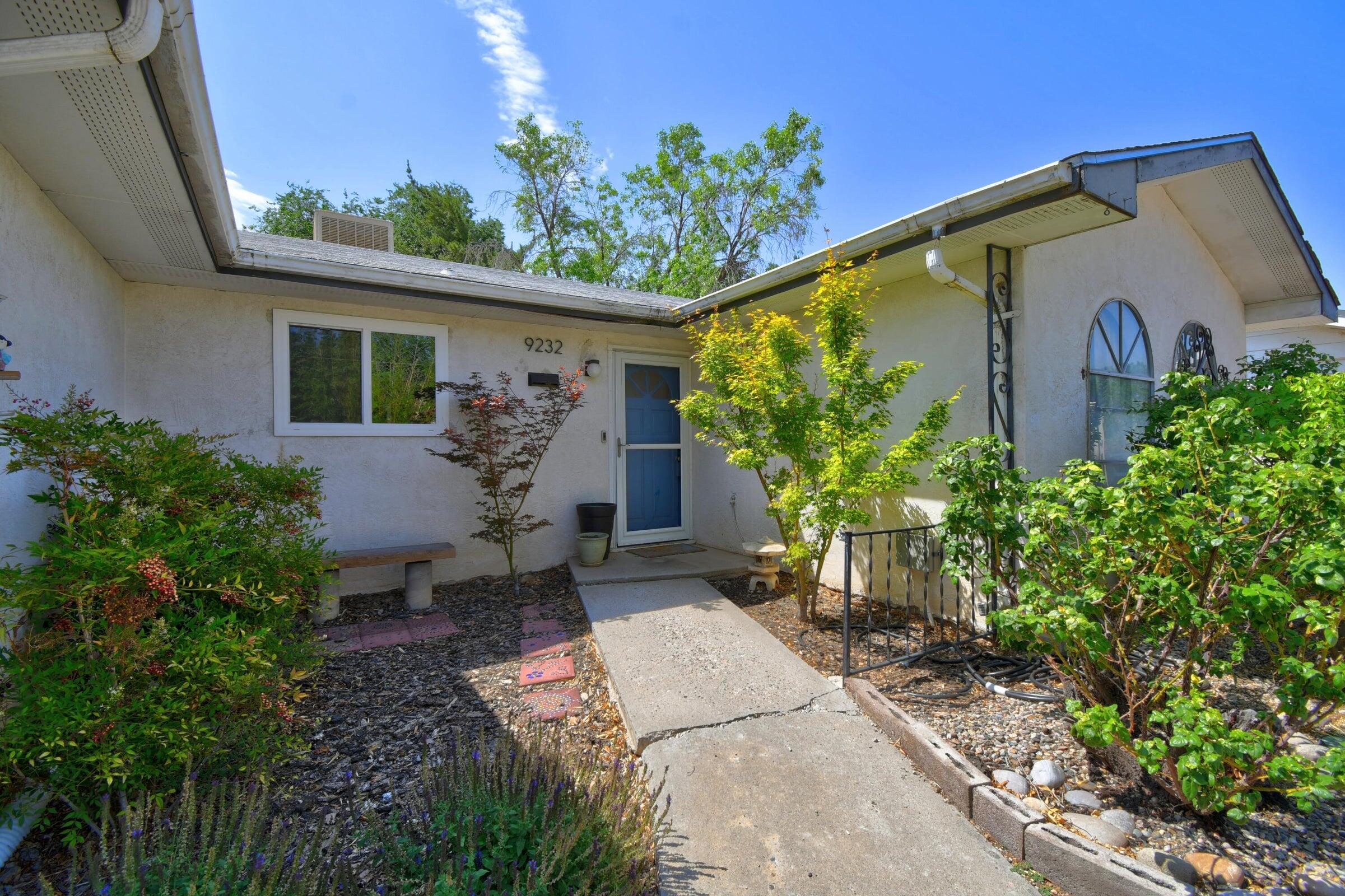 Affordable and Adorable NE Heights gem. Light and bright kitchen, recently fully updated with custom concrete countertops, mosaic tile backsplash, new cabinets, all stainless appliances. Living dining combo, and an additional living space with custom fireplace and slate flooring, Coffee table handcrafted to match fireplace conveys.  Radiant baseboard heat with new boiler, brand new carpet in bedrooms, serene park-like atmosphere in backyard, fully xeriscaped, mature trees provide plenty of shade, newer Trex deck, fire pit, and dog run, plenty of room for garden and entertaining. Custom planters and landscaping in front yard, 2 car garage. Wired for sound in backyard and kitchen.  Functional floor plan with options for comfortable living in a sought after neighborhood.