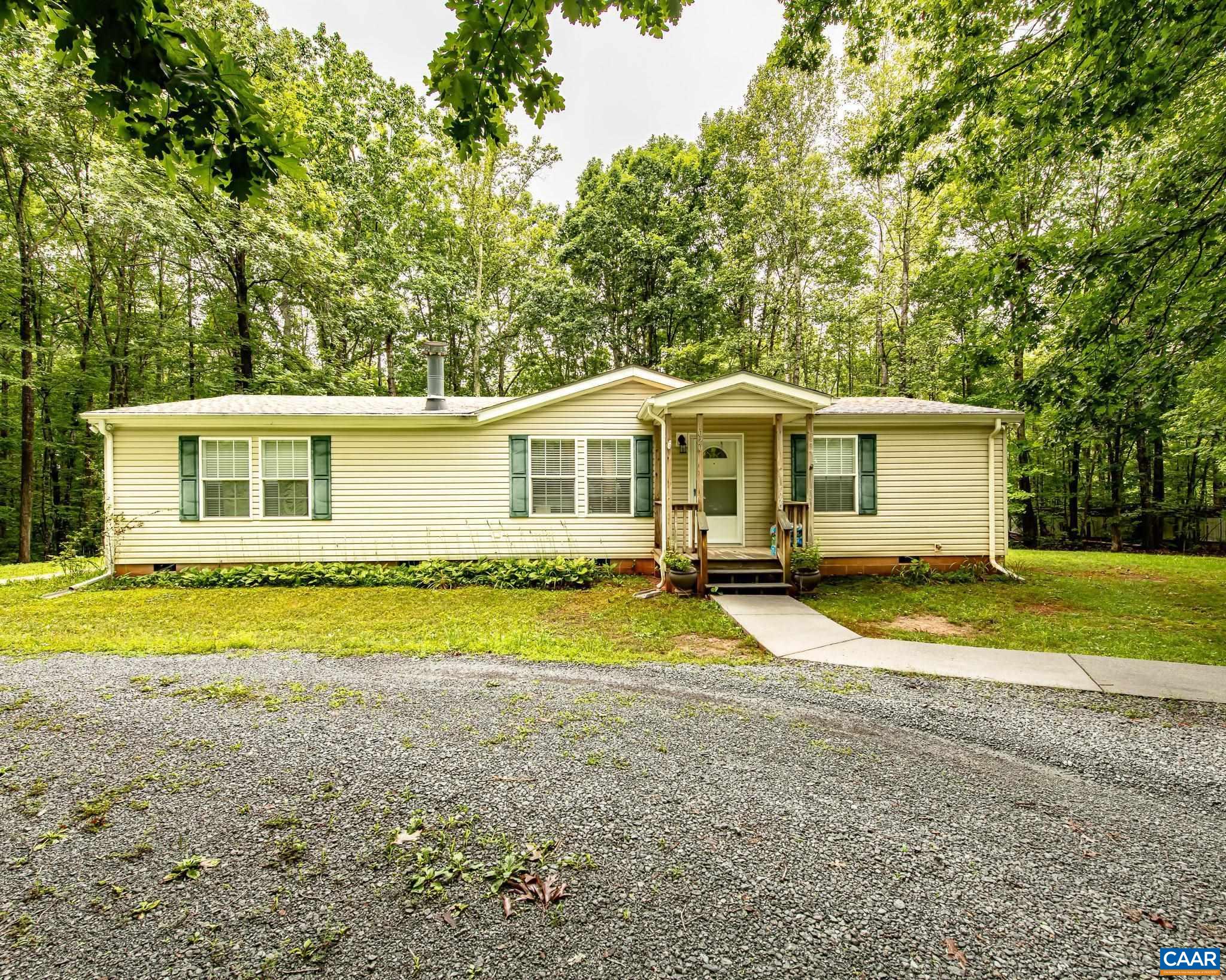 Peaceful Living on 60 acres just 5 miles from Charlottesville.  Welcome to your own private retreat just minutes from the heart of Charlottesville. Nestled on 60 wooded acres, this charming single-level 3-bedroom, 2-bathroom home offers the perfect blend of privacy, space, and convenience.  Enjoy single-level living with a thoughtfully designed open layout that connects the kitchen and dining area—ideal for gatherings or quiet nights at home. Step outside and take in the natural beauty that surrounds you, with expansive wooded views, plenty of space to explore, and endless possibilities for gardening, recreation, or even expansion.  Additional features include a detached carport, a back deck, ample outdoor space, and a serene setting that feels worlds away—yet is just a short drive to all that Charlottesville has to offer.  Whether you're looking for a full-time residence, or a property with room to grow, this unique home offers a rare opportunity to create your own haven in a truly special location.
