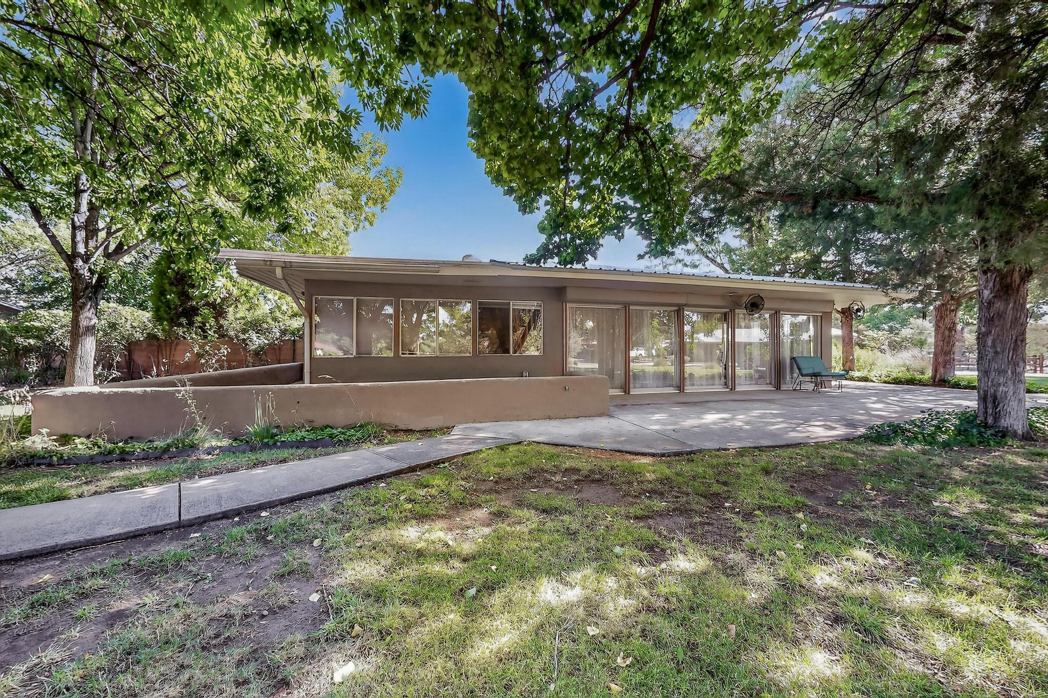 Discover the perfect blend of comfort and space in the highly sought-after Lee Acres neighborhood. Situated on an expansive .94-acre lot, this property boasts a stunning guest suite with a private entrance, ideal for visitors or multi-generational living. The heart of the home features a gourmet kitchen that flows seamlessly into a spacious living room with a cozy fireplace and a family room complete with a wood stove. The grounds are a gardener's paradise, adorned with lush landscaping, mature trees, and an herb/flower garden, all effortlessly serviced by an irrigation well. Enjoy outdoor living in the dog-friendly fenced courtyard, pergola, and two outbuildings providing ample storage for your gardening tools and equipment.