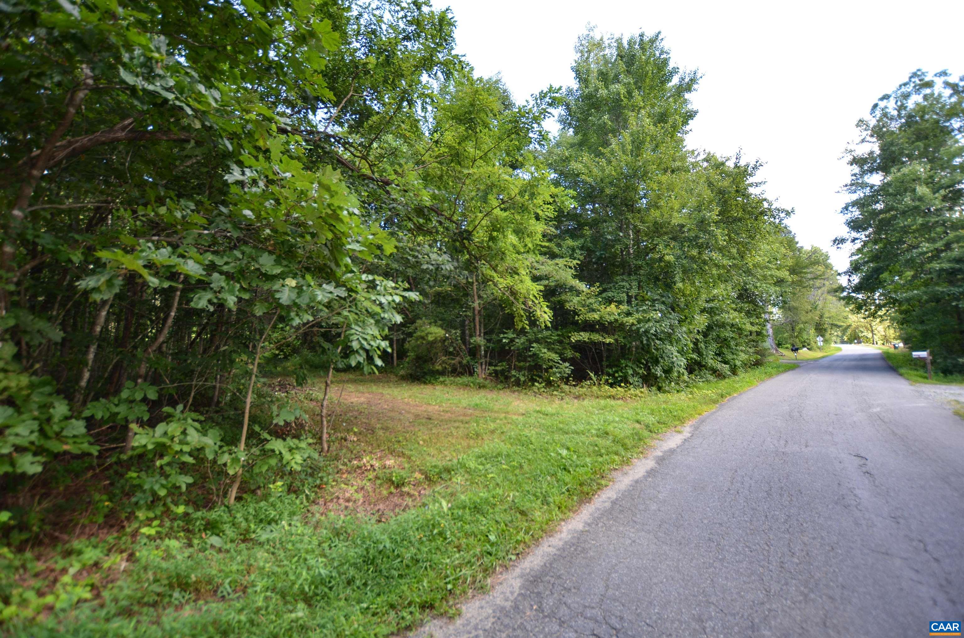 Incredible opportunity to build your dream home on 13.54 acres of mostly wooded seclusion just 12 minutes to 5th Street Station. The tranquil setting boasts a peaceful stream, native plants, hardwoods, winter mountain views and an abundance of wildlife. Whether bird watching, hunting, or just relaxing in the surrounding natural serenity you will feel miles from the hustle and bustle of city life while enjoying the conveniences of nearby shopping, dining and all things C'ville. On the gently rolling lot is a slightly elevated spot perfect for your homesite. Bring your own builder, no HOA! The entrance to the property on Dudley Mountain Rd is the right side of the property line.