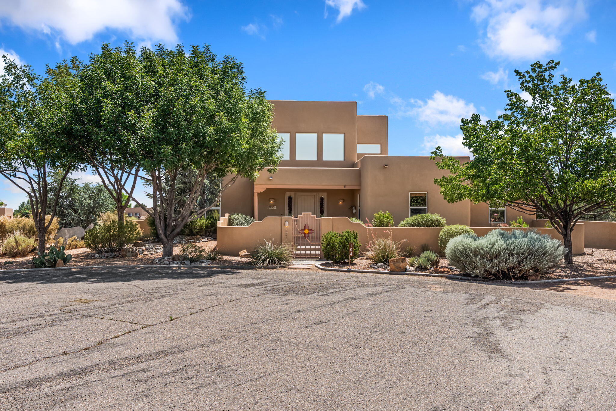 An absolutely stunning southwest sytle pueblo custom home. Hidden culdesac location, completely gated with a courtyard entry. This stunning home captivates you from the moment you walk in. High dramatic ceilings capture the views of the sandia mountains. The open concept floor plan flows seamlessly from the entrance through the greatroom w/fireplace. Gourmet kitchen w/an octagon island, custom cabinetry, SS appliances, & a walk-in pantry flows into the dining area w/access to the east patio. Retreat to the primary bedroom upstairs featuring a sitting area, dream closet, garden bath, & a private balcony to enjoy the unbelievable views. Two bedrooms downstairs w/ a full bath. Service room w/sink conveniently located near the three car garage w/ plenty of built in storage. Refrigerated air.