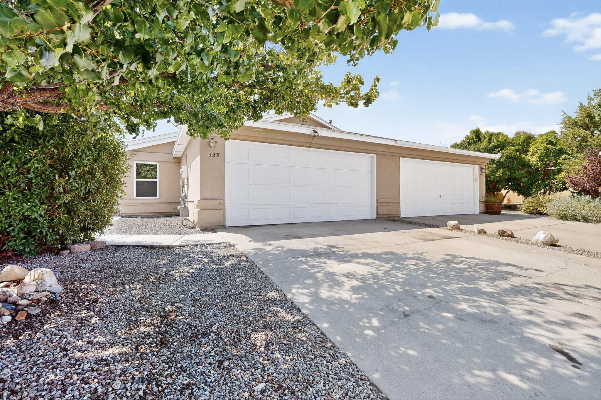 Welcome to Miravista! This well-maintained townhome offers 3 bedrooms, 2 baths, and a 2-car garage. The efficient kitchen features granite countertops and stainless steel appliances, flowing into the dining and living areas with gleaming bamboo floors and new hallway tile. Fresh paint, new carpet in bedrooms, updated bathrooms with custom tile, new baseboards, garage door/opener, front door, freshy painted garage floor and quality Hampton Bay ceiling fans add to the appeal. Enjoy a low-maintenance yard and private covered patio perfect for relaxing or entertaining. Conveniently located near I-40 and just minutes from Kirtland AFB. Ideal as a first home or investment. schedule your showing today! Some rooms in home are virtually staged.