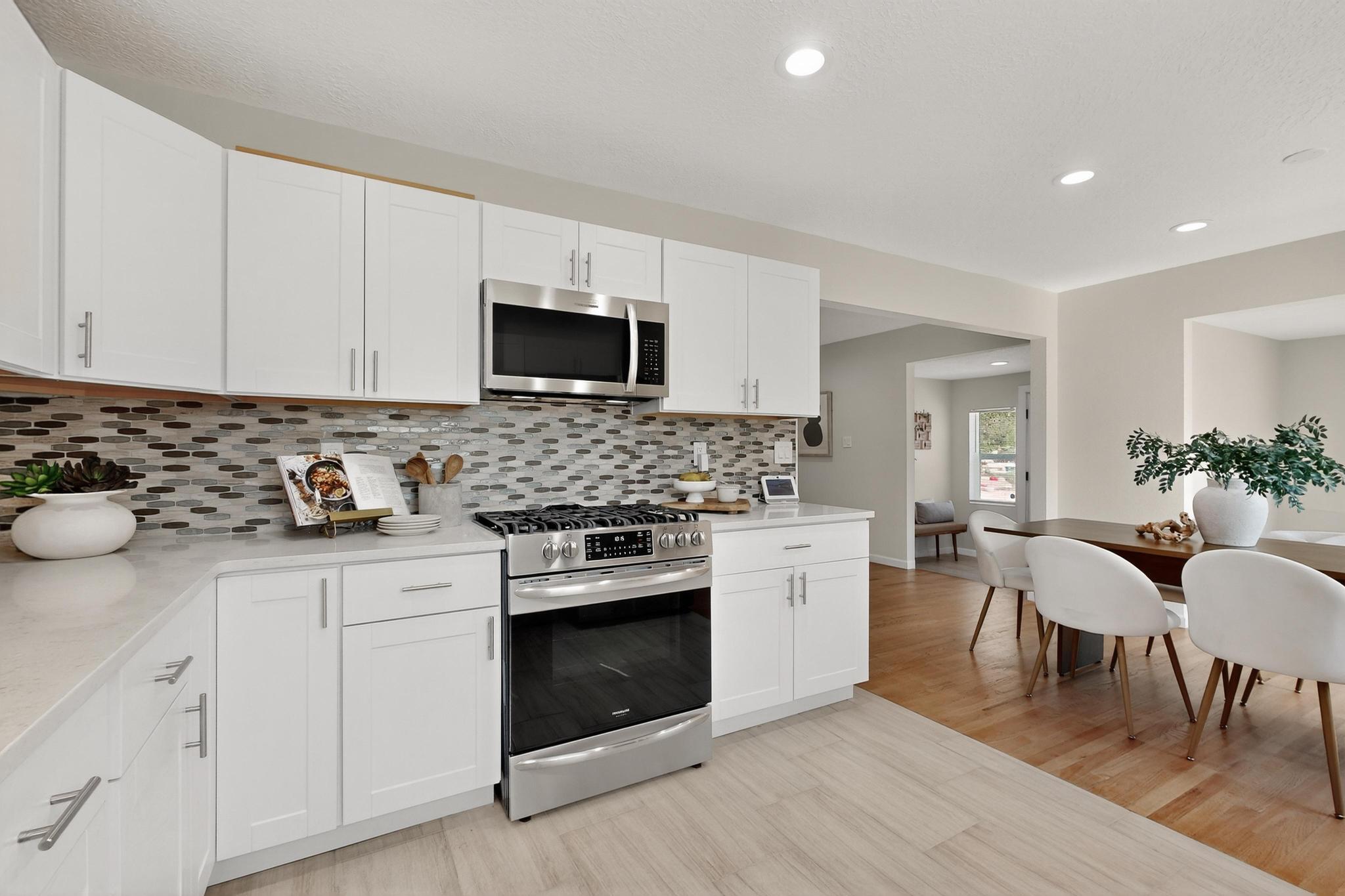 Beautifully updated 3BD/2BA with 2-car detached garage, move-in ready and full of charm. Gleaming hardwood floors flow through bright, airy spaces. The chef's kitchen invites gatherings, while the cozy fireplace creates a warm, inviting living room. A sunlit sitting nook with park and mountain views offers the perfect spot for an office, meditation, or cocktail corner. The spacious primary suite opens to a large, private backyard oasis -- ideal for morning coffee or evening unwinding. Conveniently close to VA, Sunport, UNM, and Presbyterian, this home blends modern updates with a serene, zen-like atmosphere you'll love coming home to.