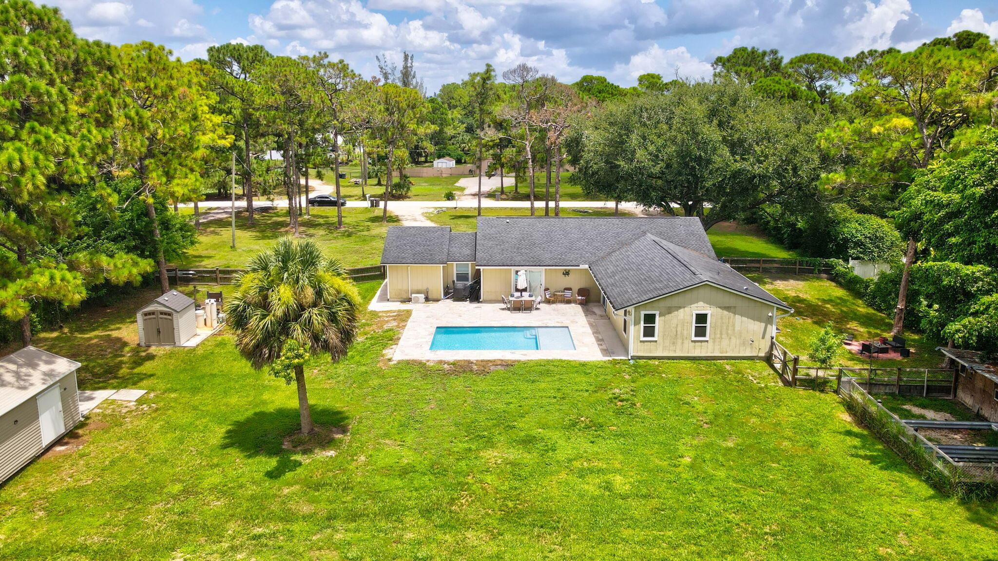 Discover the perfect blend of space, style, and serenity in this beautifully updated 5-bedroom, 3-bathroom home, set on a sprawling 1.25-acre lot. Designed for comfort and modern living, this residence boasts luxury vinyl plank flooring throughout the main house and the gorgeously updated mother-in-law suite, offering flexibility for multi-generational living or guest accommodations. The heart of the home features a sleek kitchen with granite countertops and stainless steel appliances. The bright and airy living spaces flow seamlessly to the brand-new pool and deck, creating the ultimate outdoor retreat. Peace of mind comes with all impact windows and sliders, plus a roof that's only a couple of years old. Whether you're enjoying quiet evenings by the pool or hosting