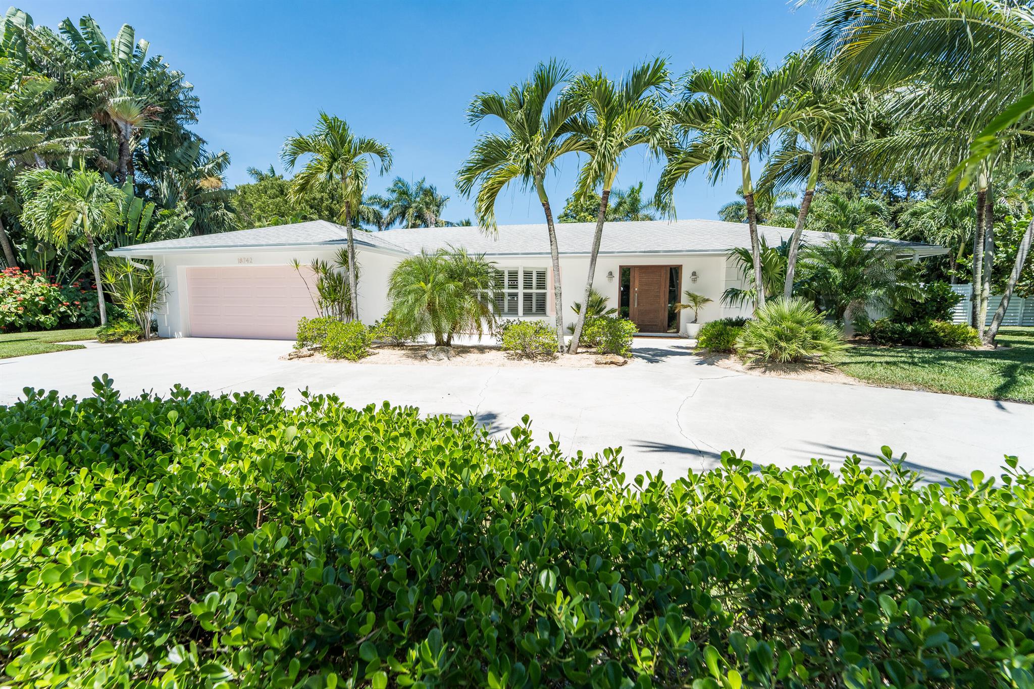 Anchorage Point Tequesta!! Rarely available interior lot -1 out of 9- located in the exquisite Anchorage Point surrounded by waterfront estate homes,  boast the largest interior lot by square footage. This stunning 3 bedroom, 2 bathroom home with a 2 car garage spans an impressive .43 acres|18,762 lot sq ft. This property offers both comfort and lifestyle. Enjoy the ultimate in outdoor living with a 2021 built heated pool and spa, coral deck and terrace and artificial turf for low maintenance beauty. The fully fenced in yard is enhanced with lush landscaping, creating a private serene tropical oasis. A circular drive offers both convenience and curb appeal while blending modern updates in an extremely sought after rare location. The oversized lot makes this home an exceptional find in Tequesta. The "famous" Tequesta banyan tree is just a short walk or bike ride away. Drive your golf cart from neighborhood to neighborhood while taking in the vibrant sunset over the Loxahatchee River. BONUS Anchorage Point offers a day dock just 50 steps from the property. Fish from the dock, tie your boat up, launch your paddleboard or kayak and enjoy the Jupiter sandbar. Tequesta has it all - locally owned tiki bars, restaurants, boutique shopping, beaches, golf courses, med spas and more. The Village of Tequesta's new recreational center has indoor pickleball courts, a children's built-in gym and offers a variety of classes for all ages. All of this and the charm of a small hometown Village vibe makes Tequesta the place to be.