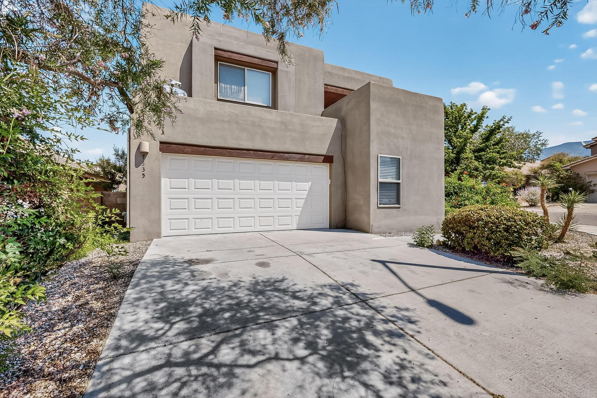 Behold something regal on Dancing Eagle! This NE Heights southwestern charmer is bright with natural light. Updates include Refrigerated Air (2023), Garage Door, Front Door, Toilets, Stove/Oven, Paint, and Carpet (all 2025)! Spacious primary bedroom includes gorgeous hardwood floors, a walk-in closet, a generous sized bathroom with a garden tub, and a huge re-stained deck (2025)! Lots of options to live here, whether in the luminous loft, the open living room and kitchen with beautiful beam ceilings and fireplace, or the covered patio in the private backyard. And, every bathroom has at least a shower! Located in a highly desirable area, minutes from La Cueva HS, Desert Ridge MS, North Domingo Baca & Noreste Parks, Paseo Del Norte & I-25...schedule a showing today!