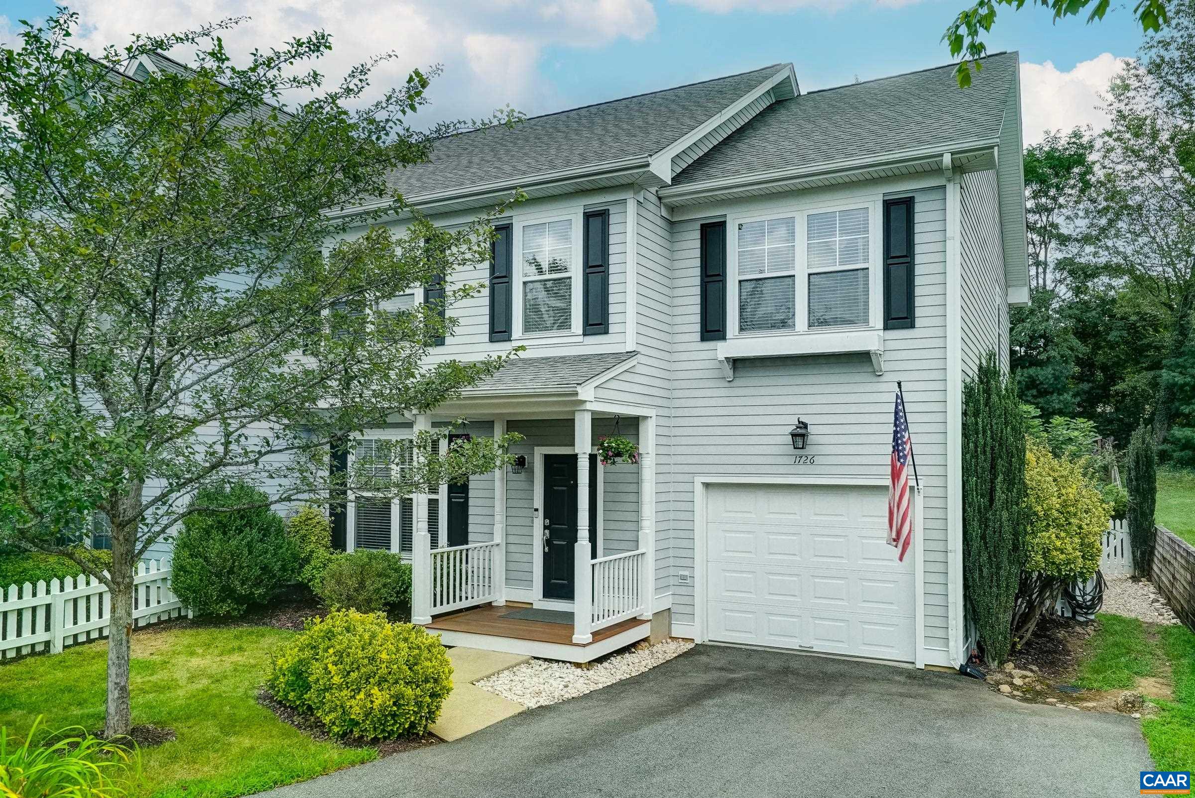 Welcome to this stunning end-unit townhome in desirable Wayland's Grant, perfectly positioned just minutes from downtown Crozet and only 15 minutes to Charlottesville. Step through the covered front porch into a beautifully maintained home featuring luxury vinyl plank flooring and neutral paint throughout. The formal dining room showcases a new dimmable chandelier, while the spacious living room boasts a gas fireplace with birch logs and painted shiplap accent wall, plus sliding doors to your private patio with canopy shade. The updated kitchen delights with solid wood cabinets, granite countertops, stainless steel appliances, breakfast bar, and pantry storage. Upstairs, the owner's suite offers a walk-in closet and ensuite with double vanity, soaking tub, and separate shower. Three additional bedrooms share a full hall bath, while the large laundry room includes LG washer/dryer and utility sink. A cozy loft with built-in bookcases creates the perfect reading retreat. Outside, enjoy the professionally landscaped, fenced backyard with multiple raised garden beds and one-car garage with storage cabinets. LED lighting and white blinds complete this energy-efficient home.