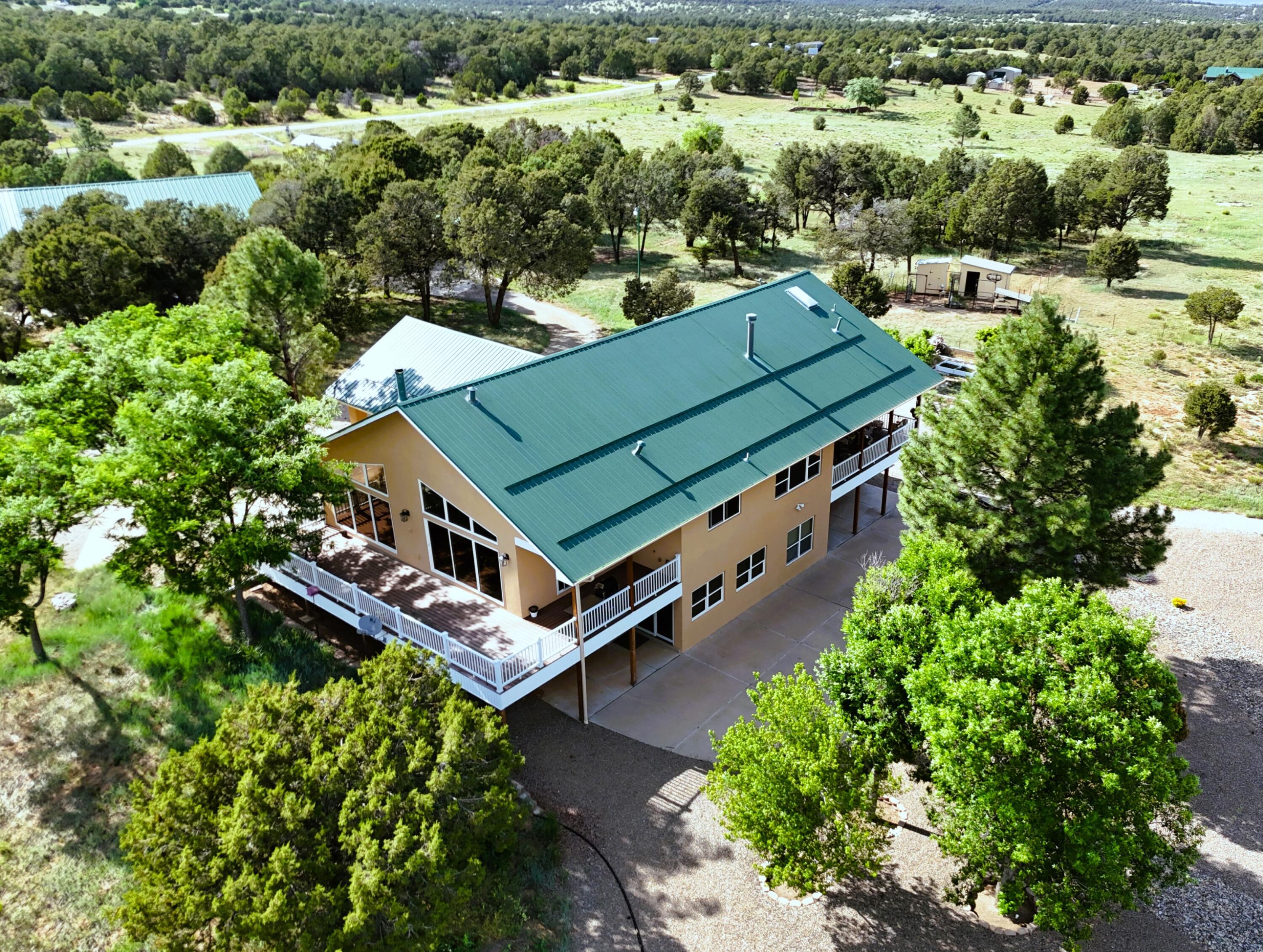 Escape to your own private mountain retreat--20 acres of serene, scenic beauty, thoughtfully developed for comfort and sustainability. This rare dual-lot property offers two fully fenced 10-acre parcels. Both lots have membership to the mutual domestic water assoc(reverse osmosis included). In addition, they share a private well and electricity. This impeccably maintained custom home features an open floor plan, boasting with natural light, radiant heat, tankless water heater, a new metal roof in 2019, new stucco in 2024 and views in every direction. A fully paid solar system covers all electric usage. The 4-car garage includes plumbing, electricity, bathroom, and a 705 sqft loft. Too many amenities to mention! See documents tab for full list! Truly a one-of-a-kind property! Welcome home!