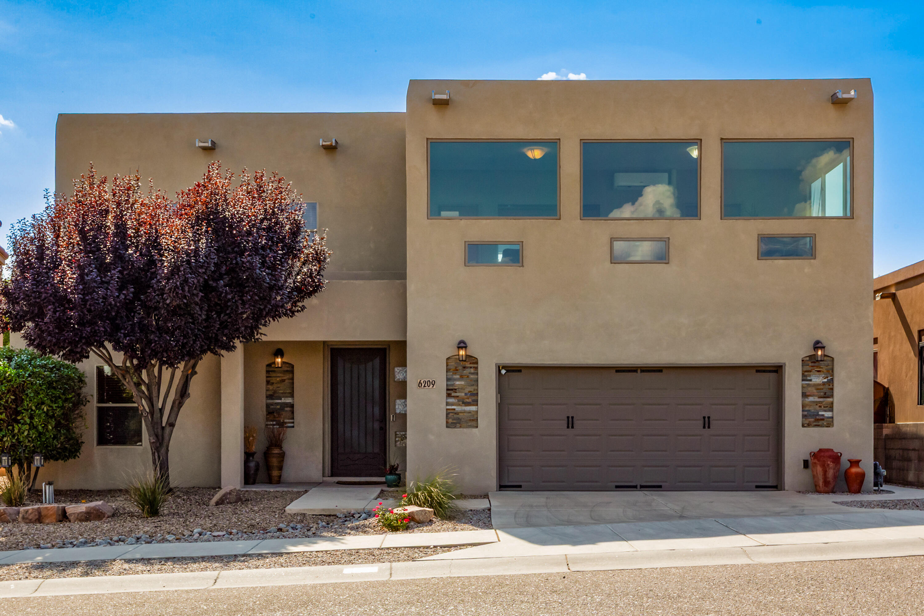 Lovely custom NW beauty is situated on a VIEW lot overlooking the Sandia Mountains & City Lights! Main living area is a wonderful space that is practical for daily living & entertaining! It offers a beam ceiling & cozy two-way fireplace. This beauty has 4 bedrooms plus office. Primary suite has spa like bathroom w/ soak tub, snail shower & large vanity. The Sunroom has Fantastic Views! It can be used as a second living space/flex room. Gourmet dine-in kitchen boasts stunning cabinetry, stainless steel appliances, bar top seating, island & tons of countertop space!Additional Interior features include; elegant metal entry security door w/ wood entry door, custom interior wood doors, gorgeous wood flooring,tile,carpet,walk in closets refrigerated air,formal dining,skylights,oversized laundry