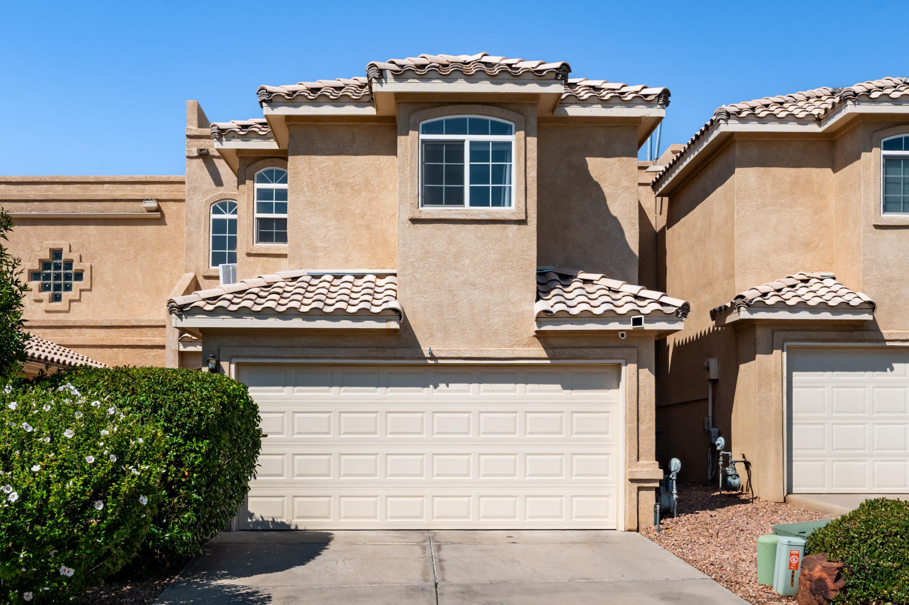 Move-in ready and beautifully updated, this townhouse in the desirable Far NE Heights is sure to impress. Recent updates include stainless steel appliances, carpet replaced in 2024, a TPO roof installed in 2020, a new furnace in 2020, plus a Ring doorbell and newly installed security door. The bright, open floor plan is filled with natural light and features a cozy gas log fireplace in the living room. Step outside to the backyard retreat with lush landscaping, mature trees, and a covered patio perfect for relaxing or entertaining. Ideally located near top-rated schools, shopping, restaurants, entertainment, and the Oso walking trail, this home offers both comfort and convenience in a prime location.