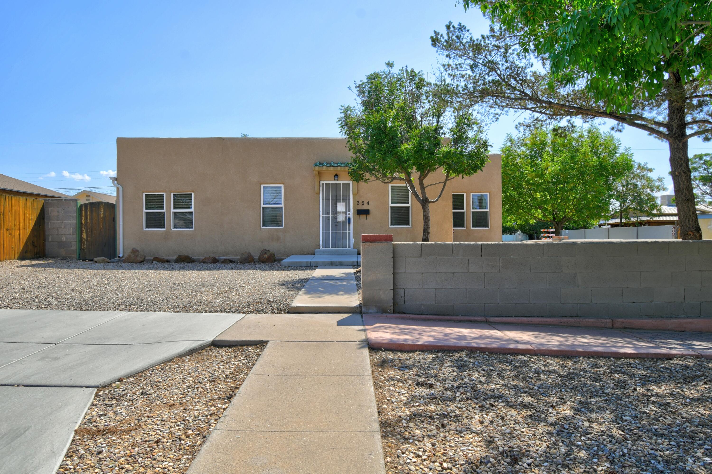 You will be captivated by the warmth and beauty of this stylish home! Single level. Excellent floor plan. 4 bedrooms. 2 updated bathrooms. Two bdrms/one bath on one side of the house, and Two bdrms/one bath on the other side. Updated kitchen w/bar top opens to dining rm and living rm. Appliances convey; including the stackable washer and dryer in laundry room. Newer carpet. Refrigerated A/C.  Double paned windows provide peace and quiet. TPO Roof.  Energy efficient. Beautifully Maintained! Wonderful private backyard. Detached garage. Large driveway w/ plenty of Off-Street Parking.  Absolutely amazing location! Three blocks to UNM. Half a mile to CNM. Walk to UNM, CNM, Nob Hill, Shopping, and Dining. Easy access to to Hospitals, KAFB, VA, Airport, Downtown & Freeways.  Come see!