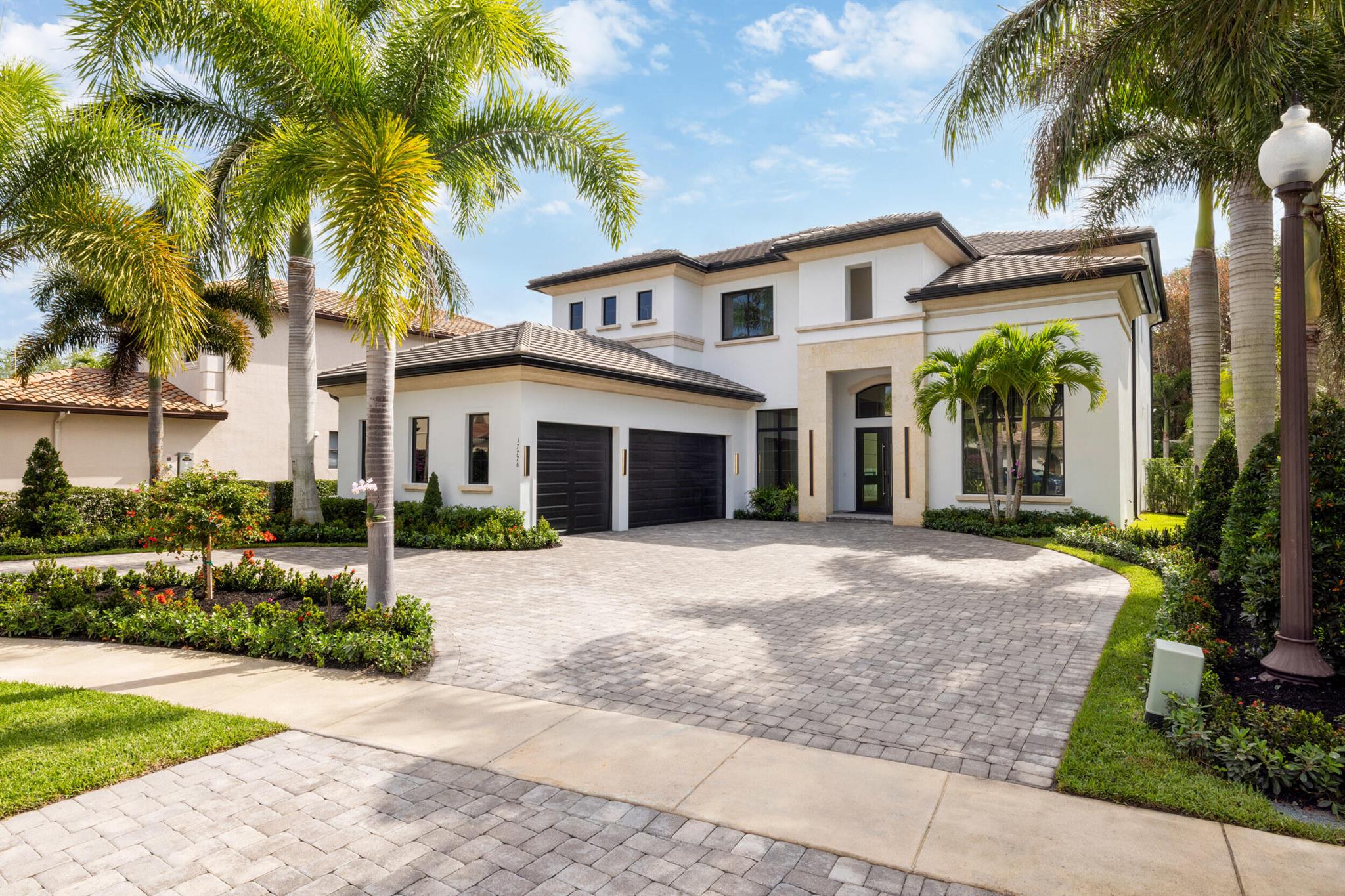 Nestled within the prestigious Oaks of Boca Raton, this extraordinary estate transcends mere property--it's a legacy in the making. Spanning an impressive 5,044 square feet, with a total of 6,877 square feet of luxurious living space, this residence is designed for those who appreciate the finer things in life. Step inside to discover five opulent bedrooms plus a dedicated office, perfectly complemented by a customized movie theater, where cinematic dreams come to life. Every corner of this home whispers sophistication, adorned with 13 exquisite slabs of imported Italian marble and meticulously crafted white oak millwork. The gourmet kitchen is a chef's dream, featuring a Wolf gas range and Sub Zero appliances, ensuring that every culinary endeavor is a delight. Seclusion and serenity envelop you on this exclusive lot, providing a private oasis that invites relaxation. The outdoor space is a true retreat, featuring a stunning pool surrounded by new pavers and lush Astroturf, ideal for sun-soaked days and enchanting evenings. An outdoor kitchen elevates alfresco dining, making every gathering a memorable experience.

Inside, high ceilings and exquisite light fixtures create an air of grandeur, while a cozy fireplace adds warmth and charm. The carefully curated details include luxurious chandeliers, elegant stone accents, and a beautifully designed wine wall.

The masterful craftsmanship extends throughout, from the acoustic panels in the theater to the tastefully designed powder room. A magnificent bougainvillea tree, lovingly cultivated by a renowned horticulturist, The Plant Guy, adds a touch of nature's artistry to the landscape.

With a three-car garage and every amenity thoughtfully considered, this estate is not just a home&#x14;it is a sanctuary. Experience the allure of 17776 Key Vista Way, where luxury, comfort, and timeless elegance converge. Your dream lifestyle awaits.