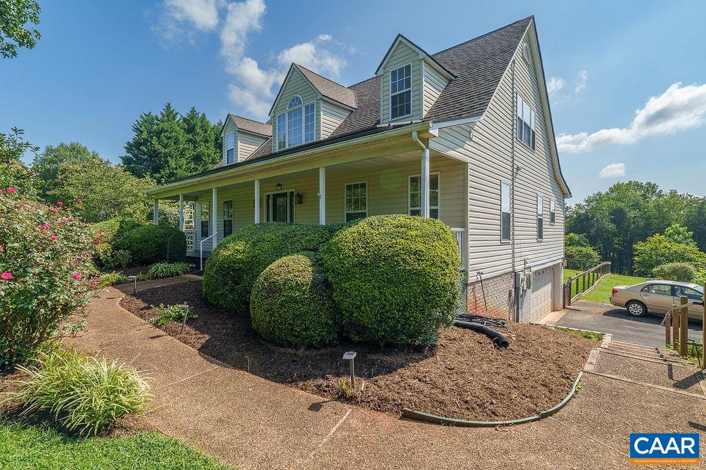 Experience the perfect blend of country charm and modern convenience in this beautifully maintained home, located just a short drive from Charlottesville. Enjoy peace and privacy on a large open lot featuring a partially fenced backyard,  blackberry bushes, asparagus, Paw Paw native plants, and even a Persimmon tree.  Step inside to find a spacious and inviting layout with hardwood floors, a cozy gas log fireplace, and dual heating. The home boasts new appliances and solar power, keeping your electric bills impressively low — averaging just $8/month!  Relax on the large back deck or covered front porch and take in the serene surroundings. The main level features a primary bedroom suite, an additional bedroom, and easy everyday living. Upstairs offers two more bedrooms, a full bath, a bonus room, and ample storage with walk-in attic spaces off each bedroom. Additional highlights include:  2-car garage, Paved driveway,  Full unfinished basement ready for expansion or storage, Spacious backyard with mature landscaping and an established garden space.  This home truly offers the best of both worlds — comfort, sustainability, and space — all in a tranquil country setting. Schedule your appointment today!
