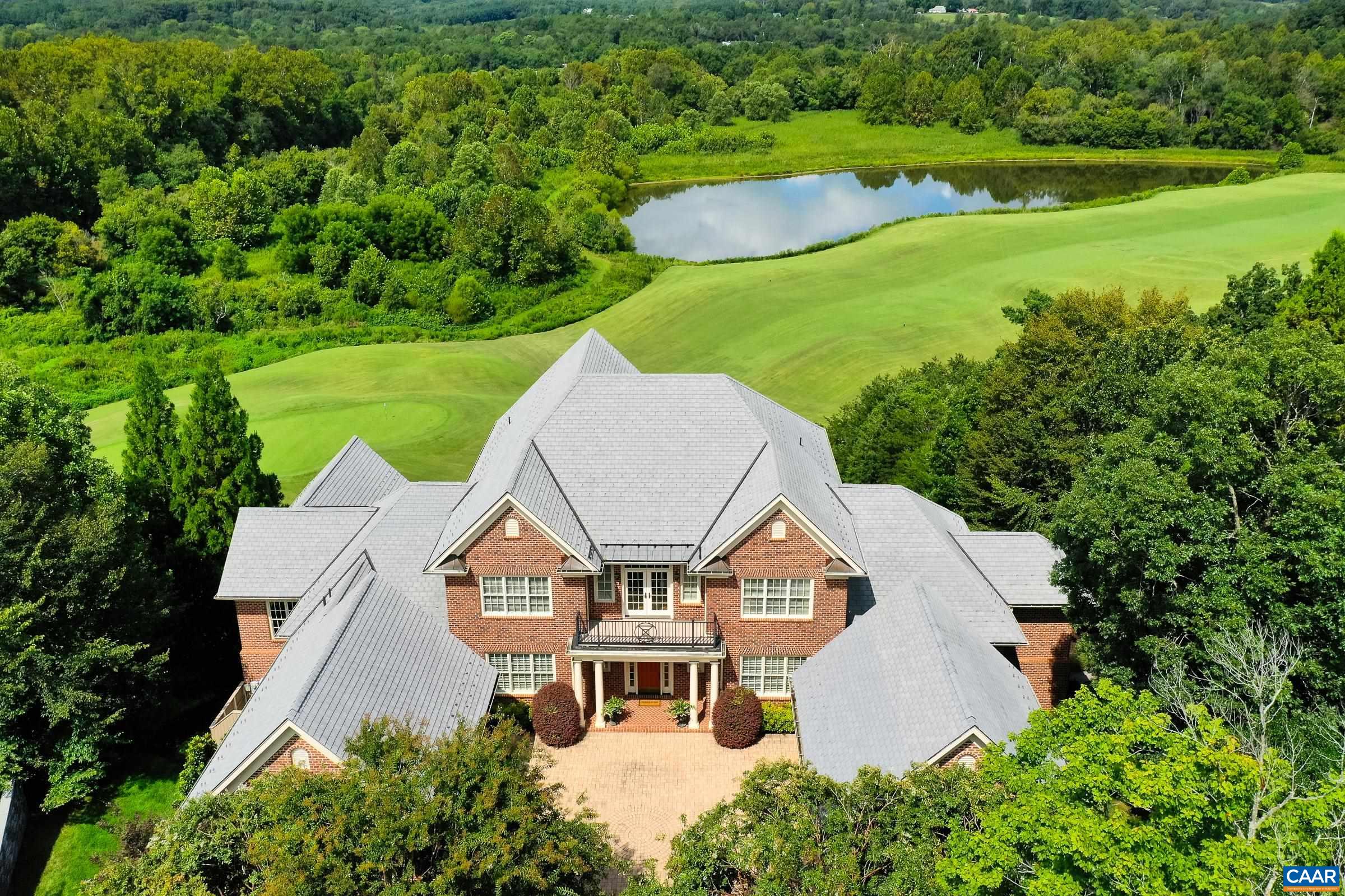 The former owner of Glenmore Club chose this location to build this exceptional, luxury estate. Why? This homesite overlooks the 17th hole of the golf course, the Rivanna River and Monticello! One could say this home offers the best views in all of Keswick and Glenmore. Enjoy the views with Pella windows and expansive back deck and terrace. Luxury abounds in this custom home designed for easy entertaining and great comfort.No expense was spared in this home including hardwood floors throughout main level, coffered ceilings, built ins and travertine surrounded gas fireplace in great room.Kitchen includes cherry cabinets, honed granite countertops, and top-of-the-line stainless steel appliances. Primary suite is a retreat with its own fireplace, sitting area, spa-like bathroom, custom shower, and incredible walk-in closet. A second main-level accessible suite is perfect for aging parents or guests. Upstairs, you’ll find four large bedrooms, each with ensuite bathrooms.  The terrace level is an entertainers dream! A large rec room with pool table and gorgeous stone fireplace, wine cellar for 500+ bottles, huge workout room and home theater.  Outdoor spaces are so inviting with expansive deck and professionally landscaped yard.