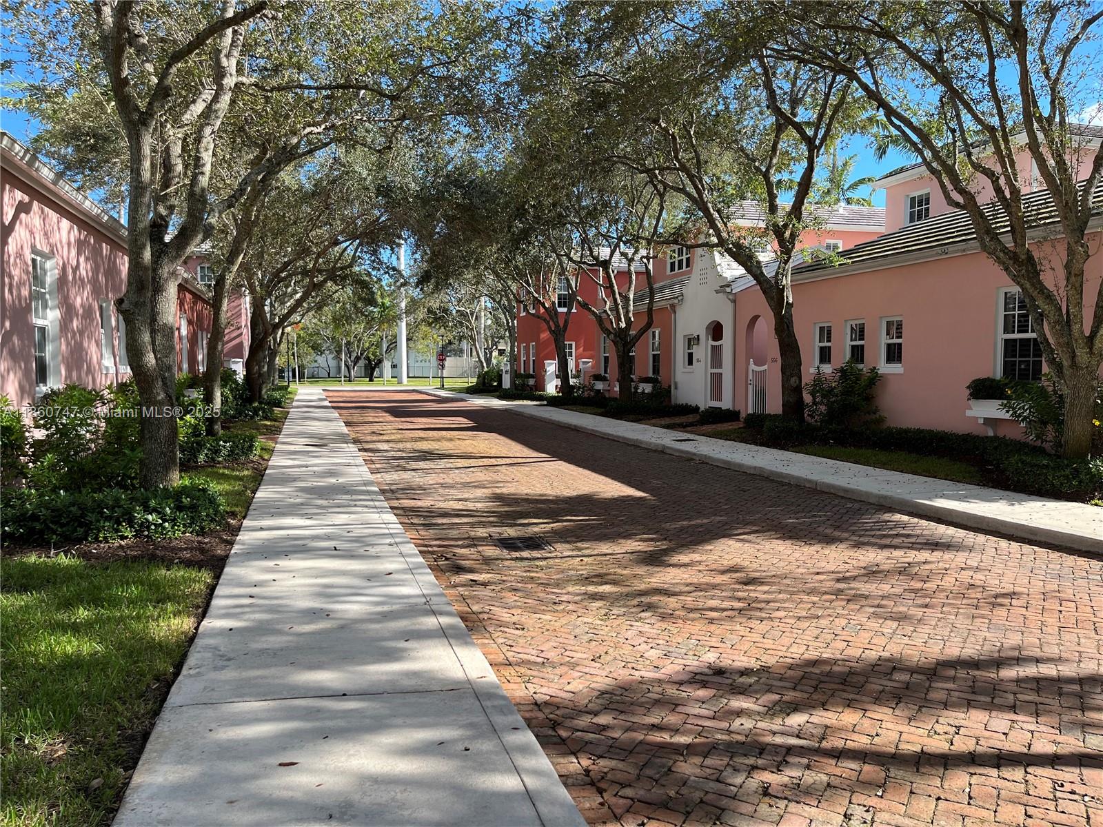 SHOWINGS START 8/30/25. Sun-filled corner villa in the unique enclave of Bermuda village in Coral Gables. Enjoy tranquil courtyard-style living in this serene townhouse surrounded by trees and conveniently located in central Coral Gables. This spacious home offers a private entry, living & dining room and one bedroom and full bath downstairs. Kitchen features granite countertops, stainless steel appliances and opens to a family room. The spacious master bedroom, walk-in closet and private master bath are upstairs, as well as an additional room and bath. Beautiful and well-appointed with 10' ceilings, 8' doors, CGI impact windows and doors, marble and wood floors, Chicago brick courtyard and two car garage. Close to US1, Merrick Park and Coconut Grove.