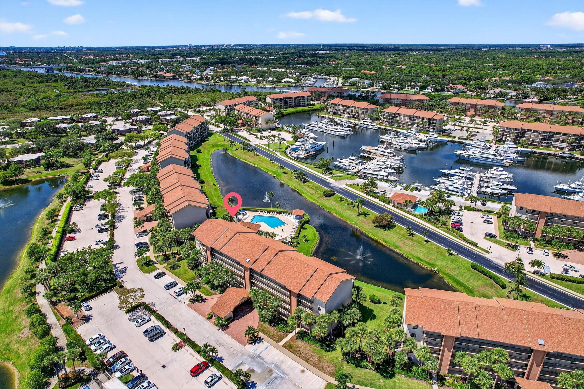 Lovely corner unit 2/2 condo in the Marina at the Bluffs. Pleasant pool, lake and Marina views with screened in balcony with rolldown sun screens & ceiling fans. All windows and doors are impact windows(2021). AC 2020, water heater 2024. new washer dryer 2023. Whole home water filter Roof replaced in 2021, elevators refurbished  2024.  Expanded Kitchen with stainless steel appliances & quarts countertops &  baths renovated within the last 5 yrs.  All assessments paid in full , all milestone work completed.