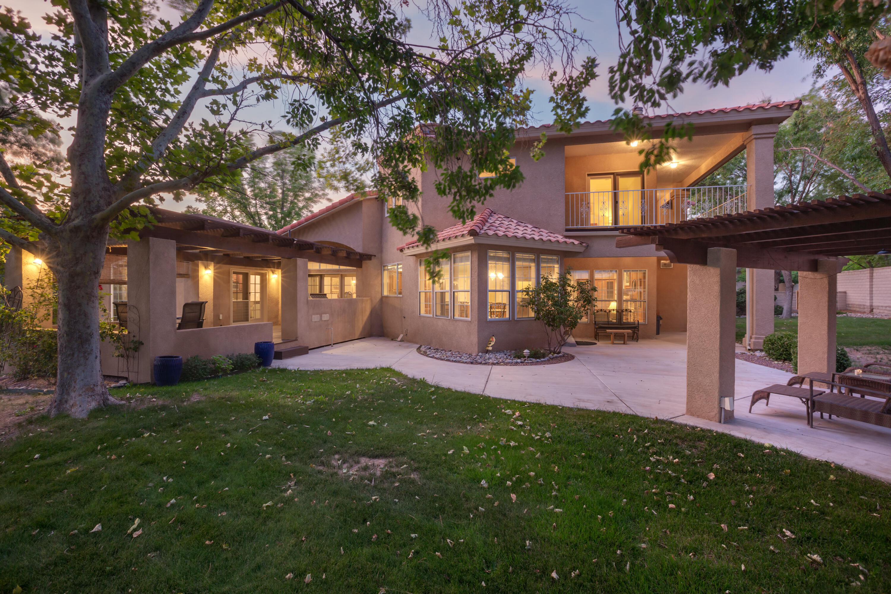 This great home is located in Albuquerque's only 24/7 guard gated golf course and country club community. This property is situated in the estate section of Tanoan West and is sits on one of the best golf course lots within the community. Backing on the fairway, this nearly half acre lot offers incredible views of the golf course while still offering privacy. An attached ground floor casita w/kitchenette offers lots of flexibility and works great for multi generational needs. In addition you will find 3 more bedrooms, an office which could be a 5th bedroom, 2 living areas, 2 dining areas and an oversized 3 car garage. Beautiful mature landscaping with lush grass and a canopy of trees offers a setting unlike many in Albuquerque. This is truly one of Tanoan's finest offerings.