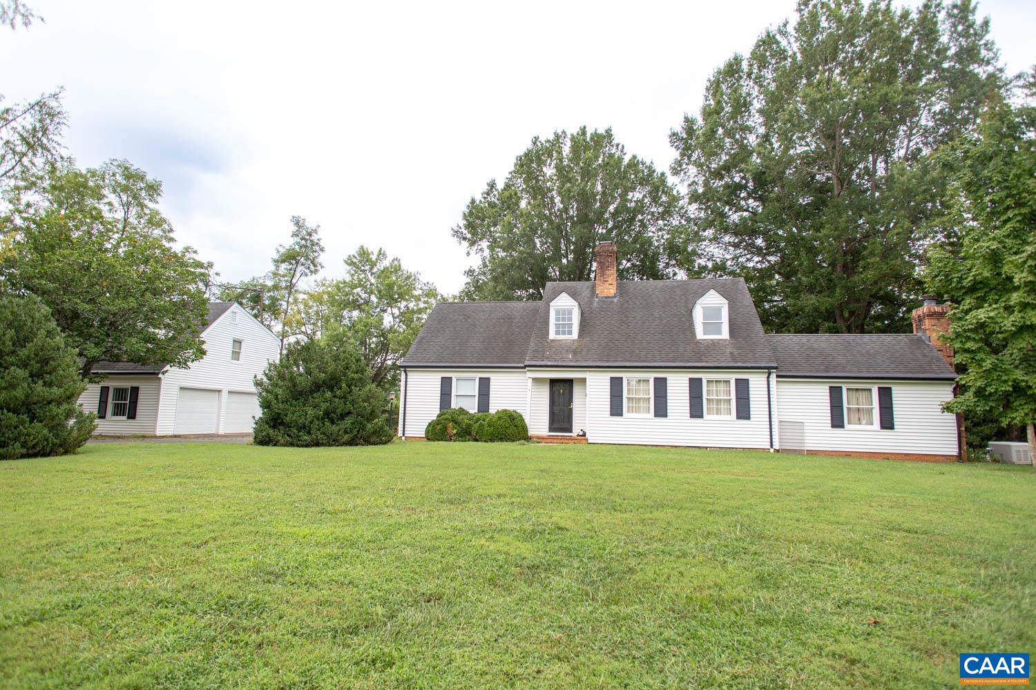 Perfectly nestled between Charlottesville & Crozet, this home is full of charming details throughout. Step inside to find a bright living room with hardwood floors & a woodburning fireplace with built-in log storage. A private office has built-in shelving & a second fireplace, perfect for a cozy work-from-home day. As you walk through the house, you’ll find a large dining room, laundry room with storage, & a bright family room with built-in seating & 2 exits to the backyard. The spacious eat-in-kitchen includes a woodburning stove creating a cozy space for relaxing in winter. The main level also includes a full bath, 2 bedrooms, and plenty of storage space. Upstairs, find a third brightly lit bedroom and a generous primary bedroom with third woodburning fireplace and walk-in closet that joins the full bath with tiled shower. The detached 2-car garage also includes a powder room and laundry room on the ground level with a private guest space above.  The guest space includes a spacious living room, kitchenette, large bedroom, full bath, and a balcony overlooking the yard. Situated on nearly 2 acres with mature trees and plenty of space for entertaining, pets, and play. Located just minutes from dining, golf courses, & more.